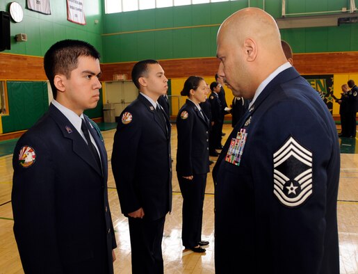 U.S. Air Force Chief Master Sgt. Kent Davis, 35th Operations Group superintendent, inspects son of U.S. Air Force Master Sgt. John Muniz, 35th Aircraft Maintenance Squadron Weapons Flight section chief, at Edgren High School Gym, Misawa Air Base, Japan, Feb. 29, 2012. The purpose of the Junior Reserve Officers' Training Corps is to teach students the values of citizenship, service to the United States, and gain a sense of accomplishment. (U.S. Air Force photo by Airman 1st Class Kaleb Snay/Released)