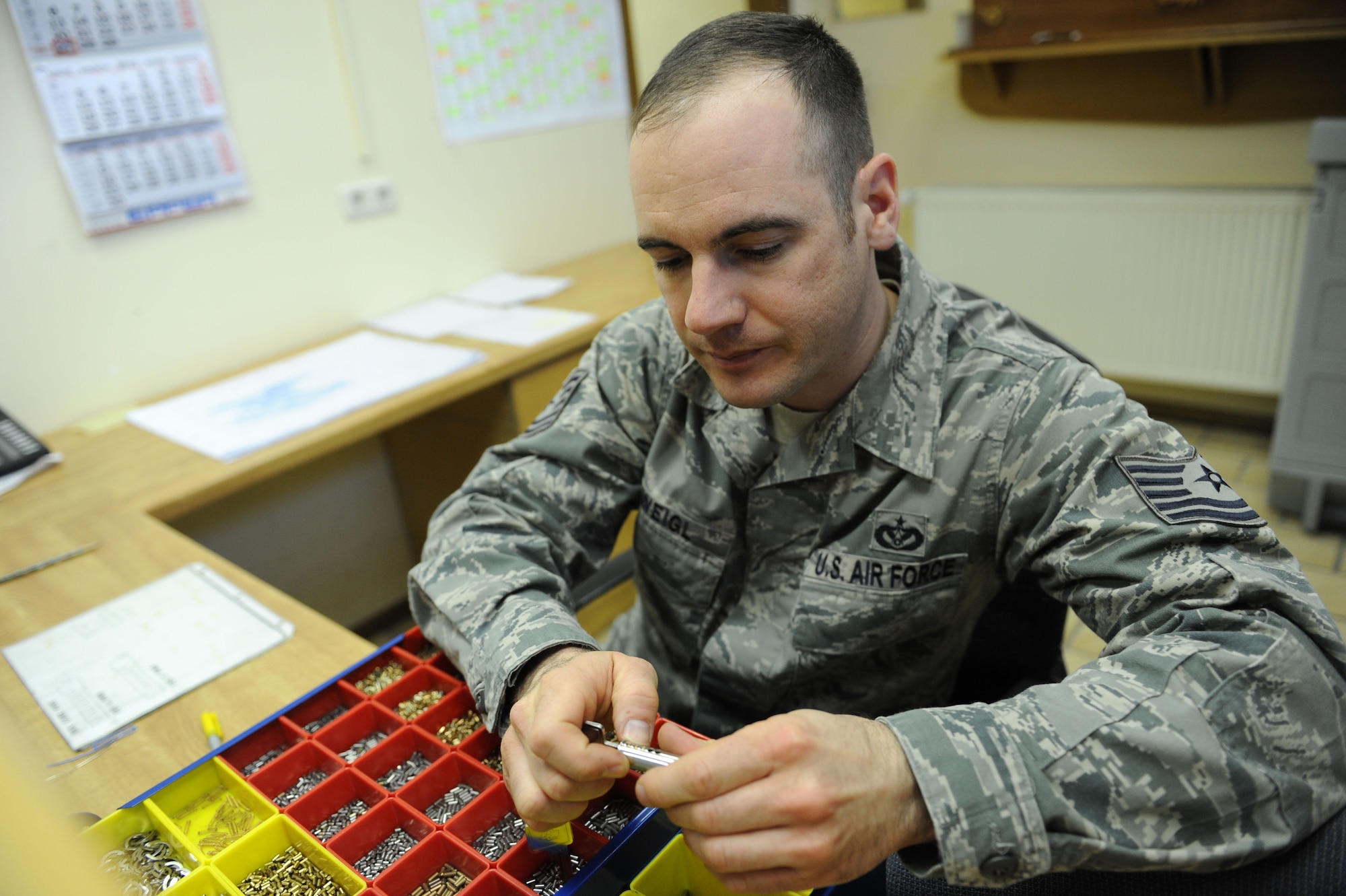 SPANGDAHLEM AIR BASE, Germany - Tech. Sgt. Damon Weigl, 52nd Civil Engineer Squadron structural craftsman, uses lock pins to match a key to a new lock in the lock shop at Bldg. 120 here Feb. 28. The lock shop performs maintenance on safes, doors, vaults and a variety of different locks and keys. The shop provides support to Spangdahlem AB and all its geographically separated units keeping more than 1,700 facilities secure. This support keeps facilities secure keeping our base safe for air force assets and airman and their families.  (U.S. Air Force photo by Senior Airman Christopher Toon/Released)