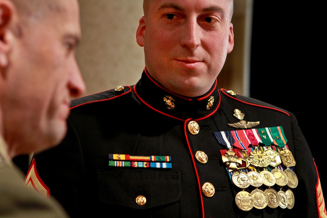Marine Corps Master Sgt. Brian M. Blonder, who served multiple tours in Iraq, talks with Marine Corps Col. Todd Scott Desgrosseilliers before a reception to honor Iraq War veterans in Crystal City, Va., Feb. 29, 2012.