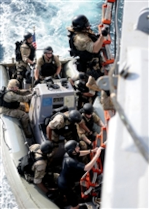 Sailors climb a ladder during visit, board, search and seizure team ...