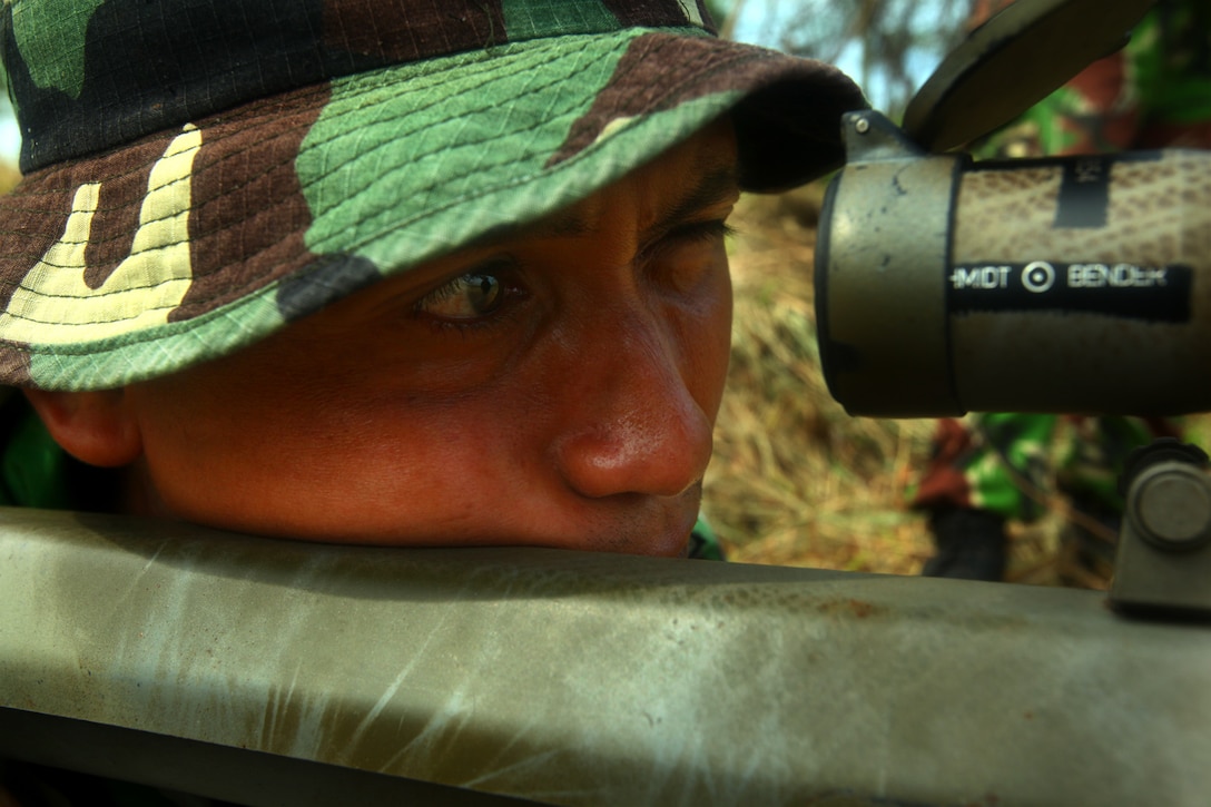 ANTRA LINA TRAINING AREA, Indonesia-An Indonesian Marine looks through the scope of an M-82 Special Application Scoped Rifle during sniper training with U.S. Marines of Landing Force Company May 29. During the sniper training, U.S. and Indonesian Marines learned to operate one another’s weapon systems. Landing Force Company is participating in Cooperation Afloat Readiness and Training (CARAT) 2011. CARAT is an annual series of bilateral exercises held between the U.S. and Southeast Asian nations with the goals of enhancing regional cooperation, promoting mutual trust and understanding, and increasing operational readiness. While in Indonesia, the service members from both nations train together on martial arts, military operations on urban terrain, jungle warfare, combat marksmanship and combat lifesaving.