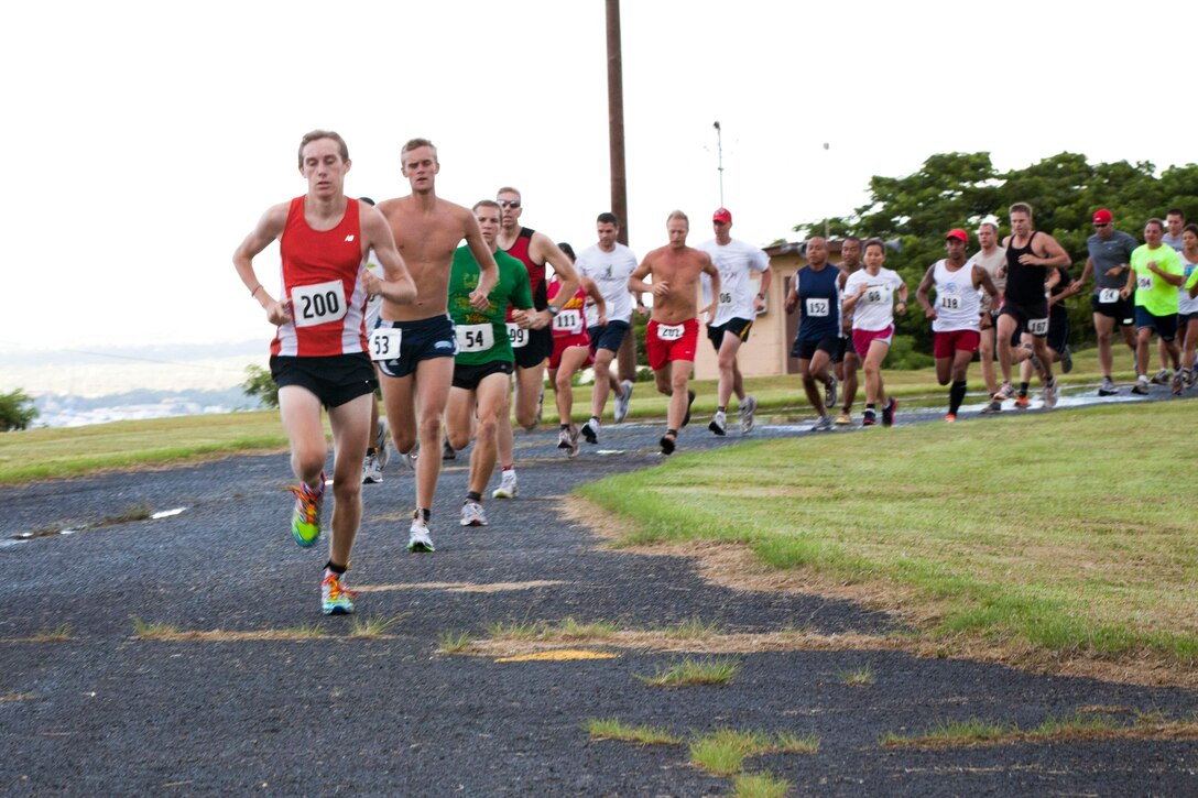 CAMP H.M. SMITH, Hawaii-Archie Robertson leads the 15th annual 5K Grueler hosted by the Marine Corps Community Services Hawaii Camp H.M. Smith Semper Fit Center here into the Aiea trails that surround Camp Smith. Robertson was the second to cross the finish line with a time of 18 minutes, 25 seconds.