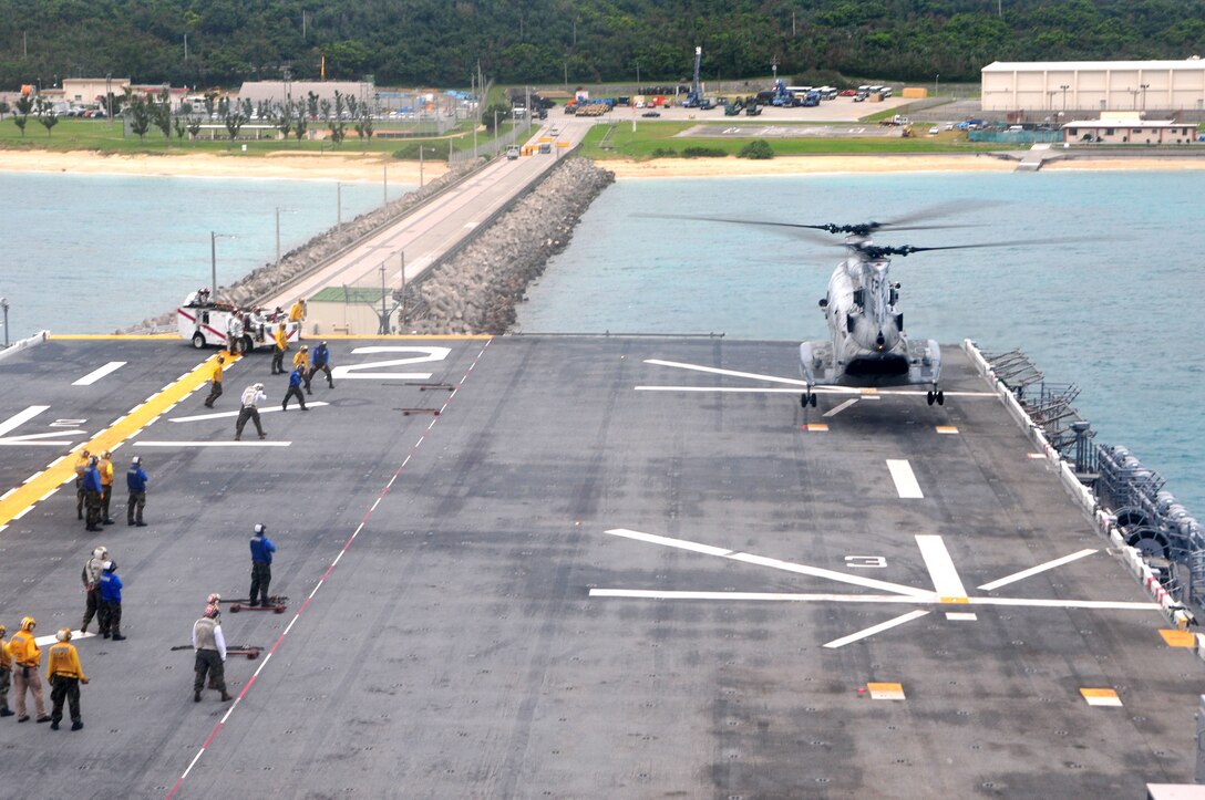 A CH-46E Sea Knight helicopter with Marine Medium Helicopter Squadron 265 (REIN) lands aboard the deck of the USS Essex (LHD-2) while docked here, March 2. The onload is part of the 31st Marine Expeditionary Unit's preparation for the amphibious integration training and certification exercise before continuing their deployment in the Asia-Pacific region.