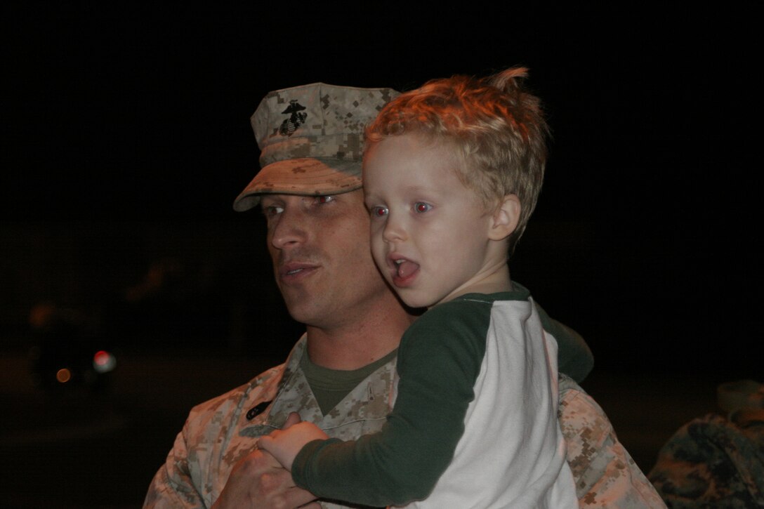Gunnery Sgt. Scott A. Pifer, an administration specialist with Marine Air Control Group 28, 2nd Marine Aircraft Wing, holds his son after returning from a seven-month deployment to Afghanistan aboard Marine Corps Air Station Cherry Point, N.C., March 2, 2012. The MACG-28 Marines provided Marine air command and control systems for the wing.