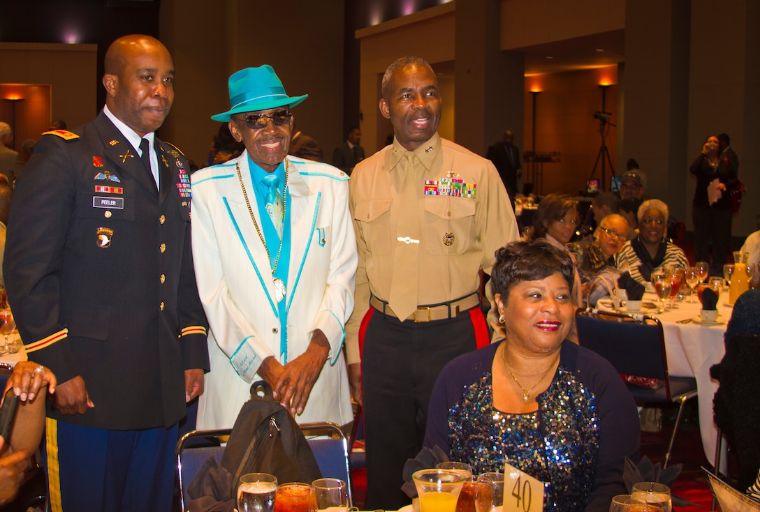Major Gen. Ronald L. Bailey, commanding general, 1st Marine Division, and Army Maj. Michael L. Peeler, professor of military science, Elizabeth City State University, pose for a photo with Abraham Mitchell at the Central Intercollegiate Athletic Association Hall of Fame induction ceremony, March 2. Mitchell, known by the moniker Mr. CIAA, is well known for his outfits and enthusiasm at CIAA basketball games.