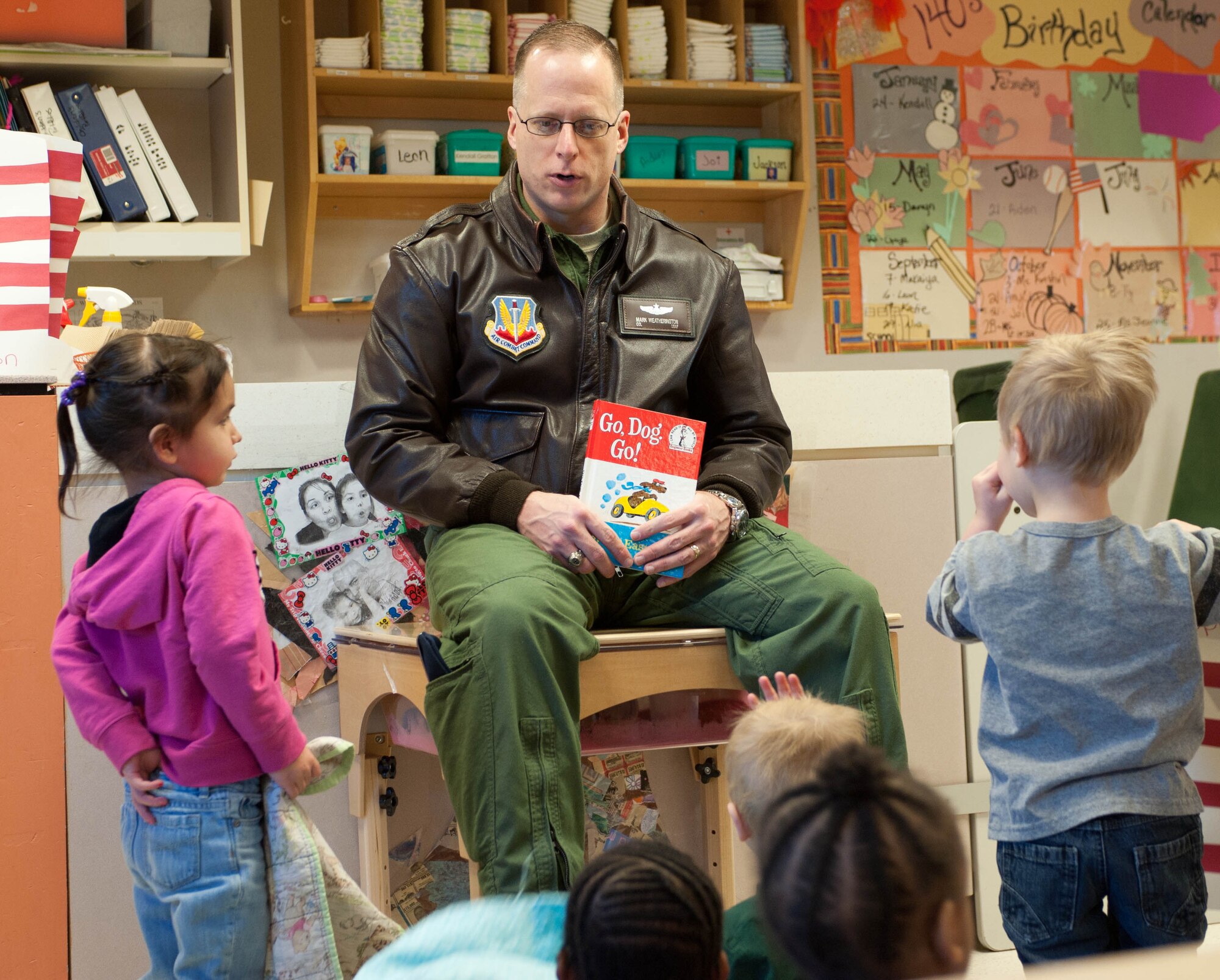 Col. Mark Weatherington, 28th Bomb Wing commander, reads “Go Dog Go” to a group of 2-year olds during a Read Across America event at the Child Development Center at Ellsworth Air Force Base, S.D., March 2, 2012. Read Across America is an annual event designed to motivate children to read. (U.S. Air Force photo by Airman 1st Class Zachary Hada/Released)