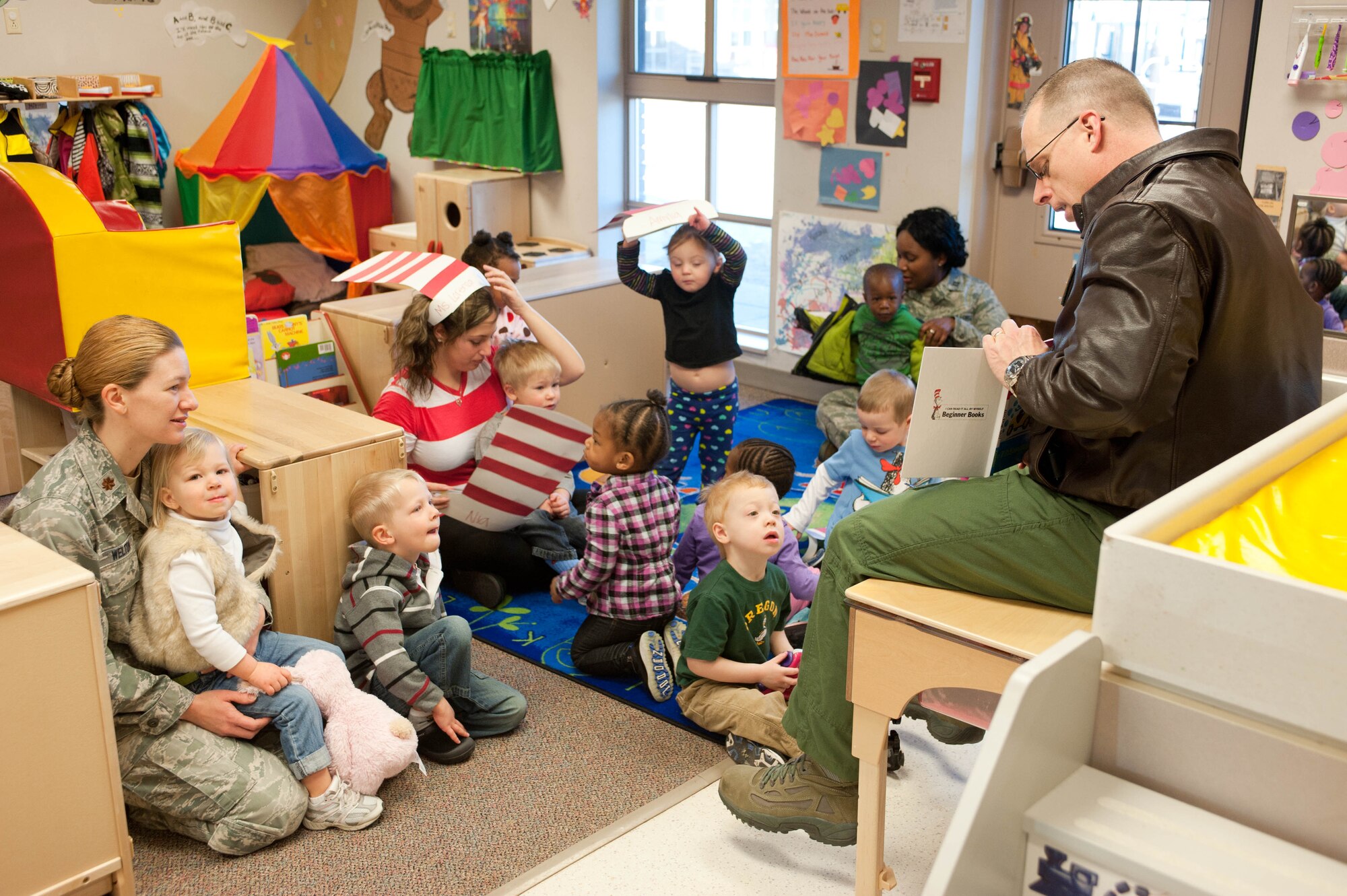 Col. Mark Weatherington, 28th Bomb Wing commander, reads Dr. Seuss stories to a group of 2-year-olds at the Child Development Center at Ellsworth Air Force Base, S.D., March 2, 2012. The Read Across America program exposes children to literature and celebrates the birthday of Dr. Seuss. (U.S. Air Force photo by Airman 1st Class Zachary Hada/Released)