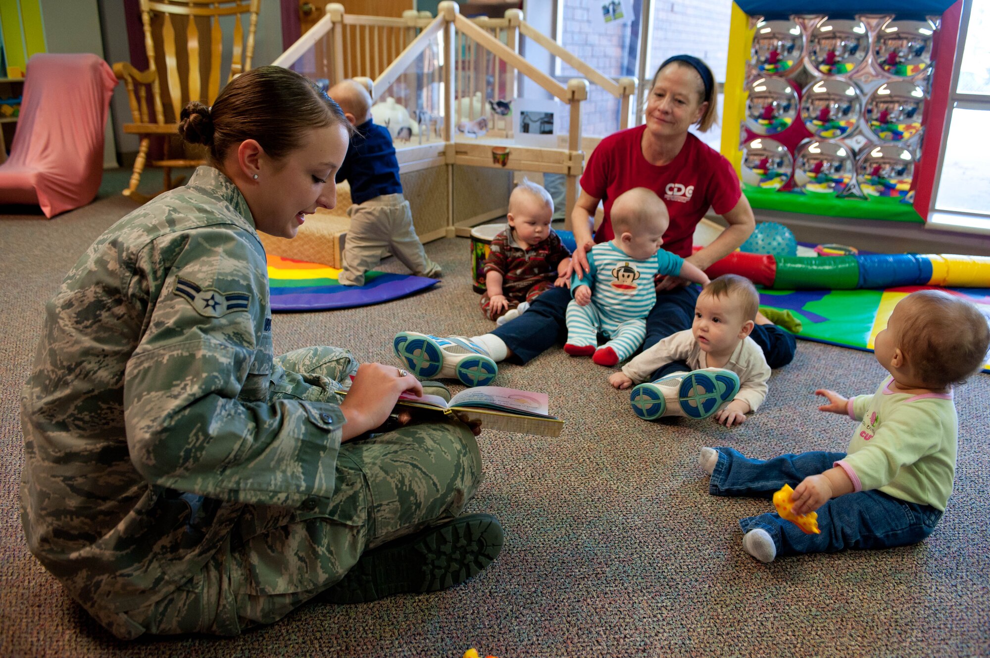 Airman 1st Class Leslie Hibbitts, 28th Contracting Squadron contract administrator, reads “One Fish Two Fish Red Fish Blue Fish” to a group of 6-month-old children at the Child Development Center at Ellsworth Air Force Base, S.D., March 2, 2012. Airmen volunteers took time to volunteer to read to children at the development center. (U.S. Air Force photo by Airman 1st Class Zachary Hada/Released)