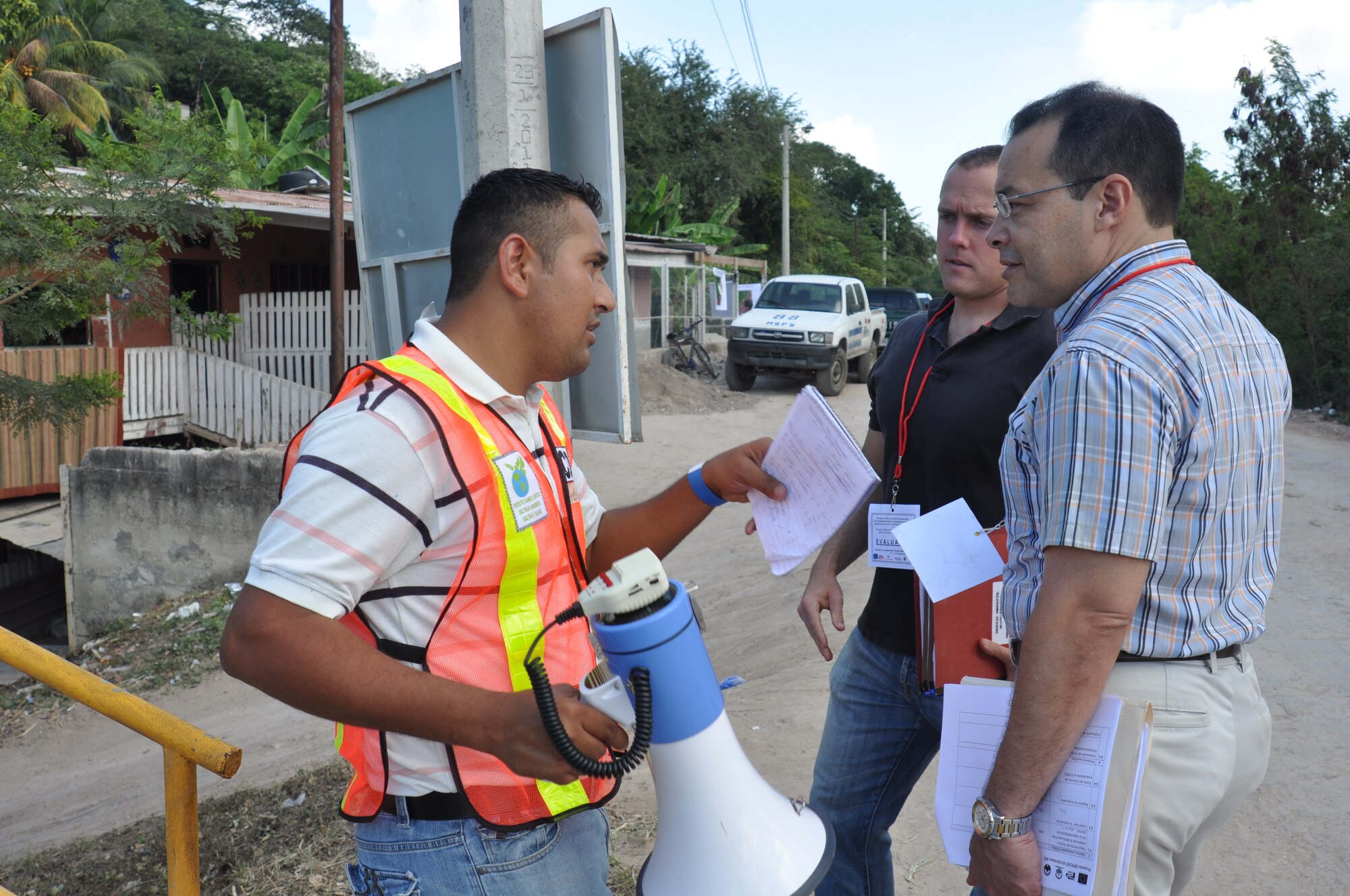 SAN PEDRO SULA, Honduras - Dr. Ricardo Aviles, a Medical Officer at the Medical Element, and Capt. Tyler Grunewald, the deputy director of MEDEL operations setion, speak with a community member about the COPECO exercise here last month. Joint Task Force-Bravo, Soto Cano Air Base, Honduras, sent members of the Central America Survey Assessment Team to serve as evaluators during a two-day Foreign Humanitarian Assistance and Disaster Relief preparedness exercise in the San Pedro Sula valley last month. (U.S. Air Force photo/Capt. Candice Allen)