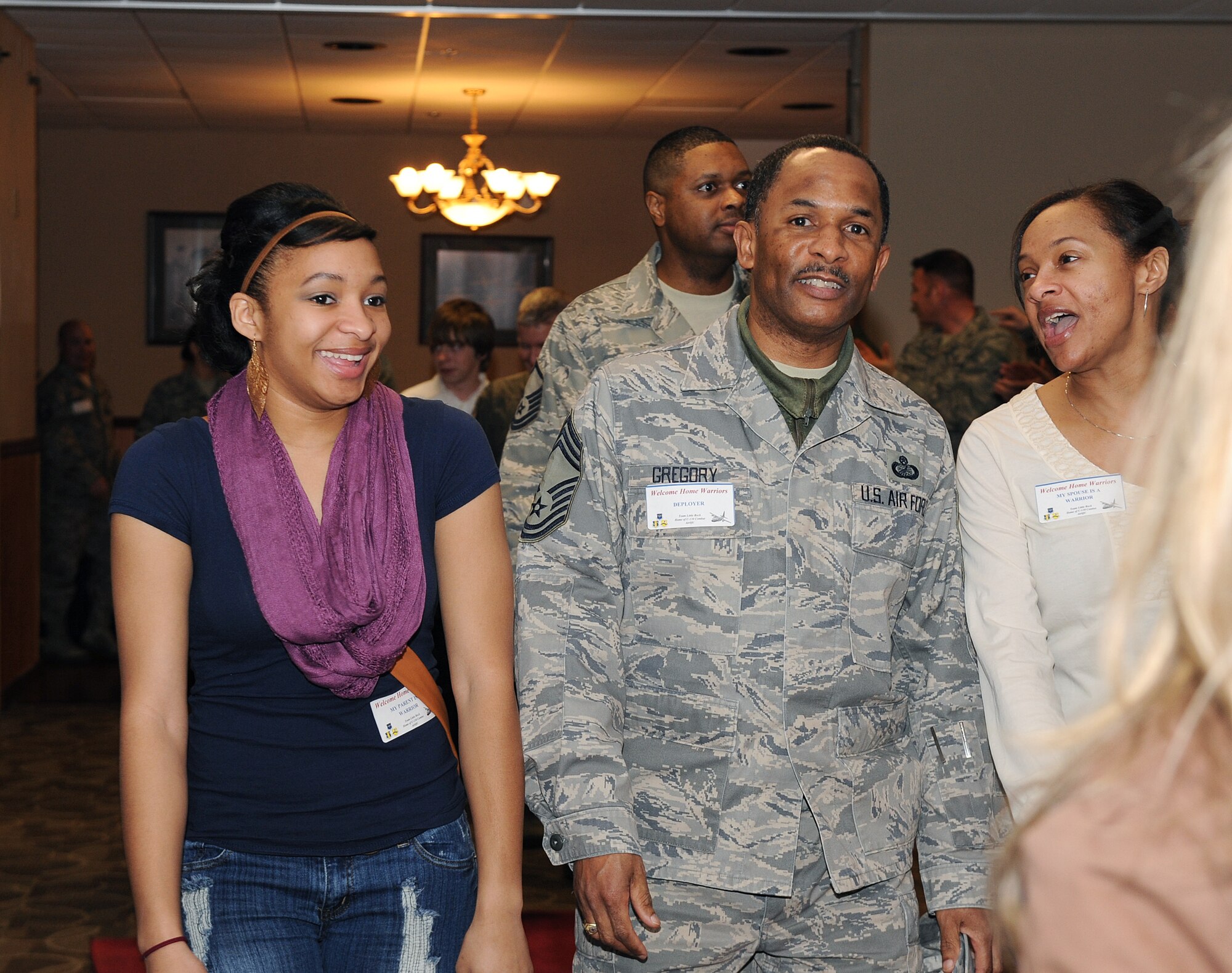 Team Little Rock members walk down the red carpet while being greeted by friends and family at the Welcome Home Warrior event on base, March 2, 2012, at Little Rock Air Force Base, Ark. The Welcome Home warrior’s event is designed to recognize deployers who returned home through in small groups, and not part of a large rotator. (U.S. Air Force photo by Airman 1st Class Ellora Remington)