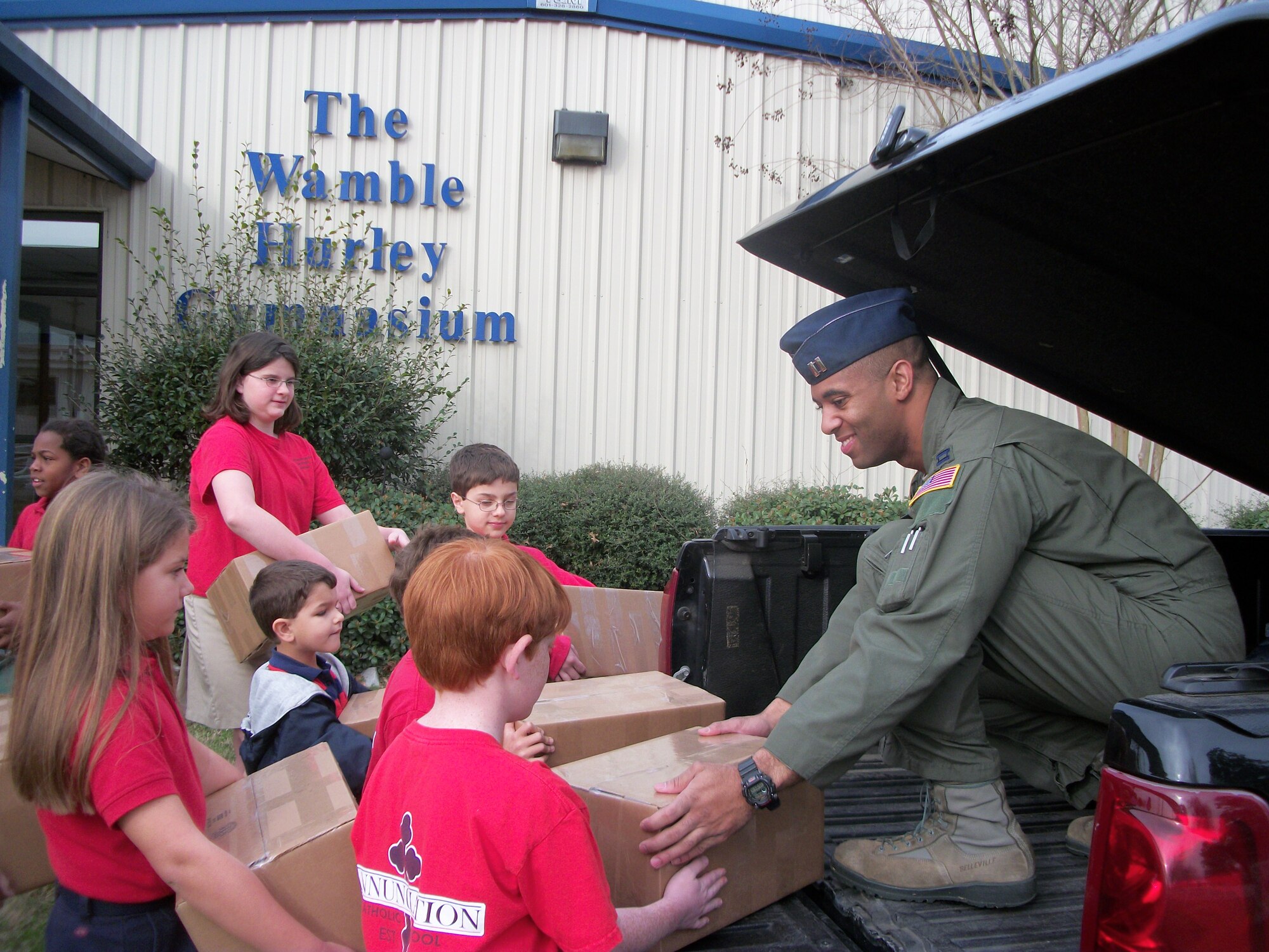 Students from the Annunciation Catholic School and Capt. Tandon Madis, 48th Flying Training Squadron load care packages bound for deployed Columbus Air Force Base members on a truck Feb. 1. The school doubled their original goal and donated a total of 20 care packages, each personalized with cards and letters written by students. (Courtesy photo)