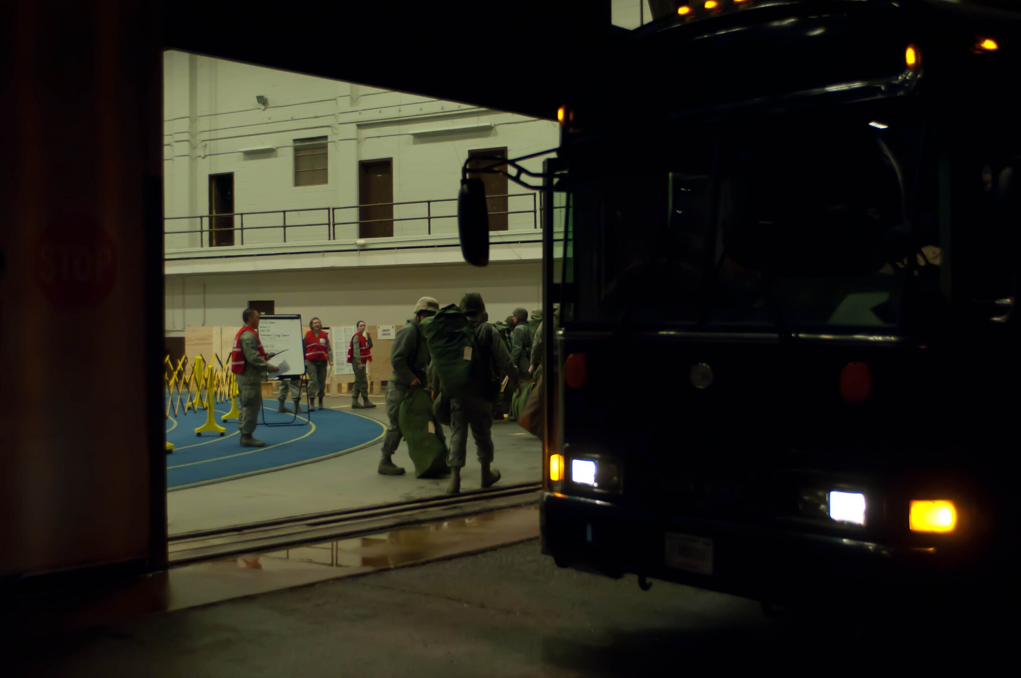 Airmen arrive at the Pride Hangar to process through the Personal Deployment Function line during an Operational Readiness Exercise at Ellsworth Air Force Base, S.D., Feb. 22, 2012. The ORE tested Ellsworth’s ability to prepare Airmen for mobilization and deployment in support of worldwide contingencies. (U.S. Air Force photo by Airman 1st Class Zachary Hada/Released)