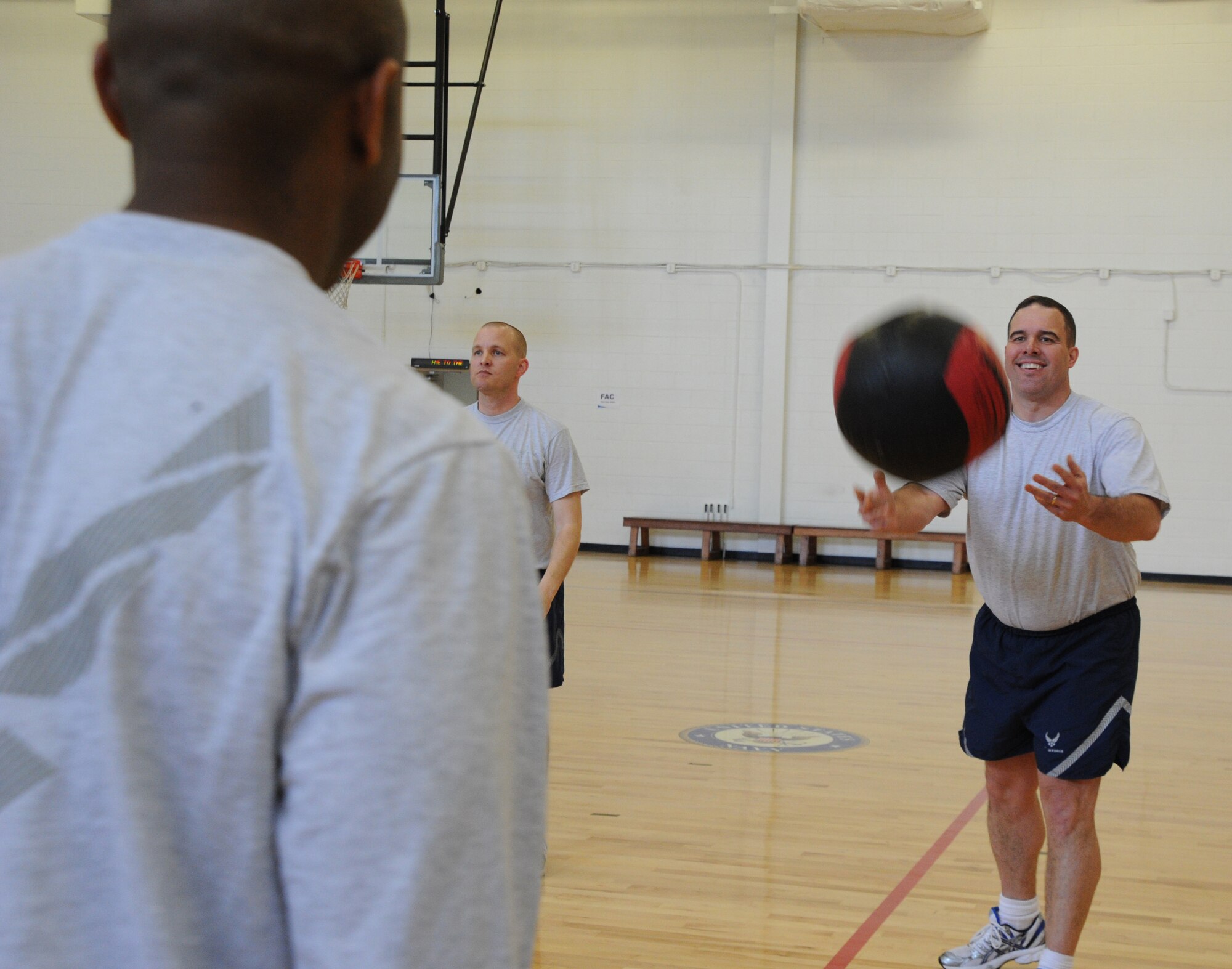 Lt. Col. Jody Ogea, Air Force District of Washington manpower and personnel
deputy, catches a medicine ball March 1 at the West Fitness Center, Joint
Base Andrews, Md. The February Fitness Challenge capstone event featured a
relay race, medicine ball toss, blind free throws, a three-legged race and
Dodge ball. (U.S. Air Force photo by Airman 1st Class Tabitha N. Haynes)
