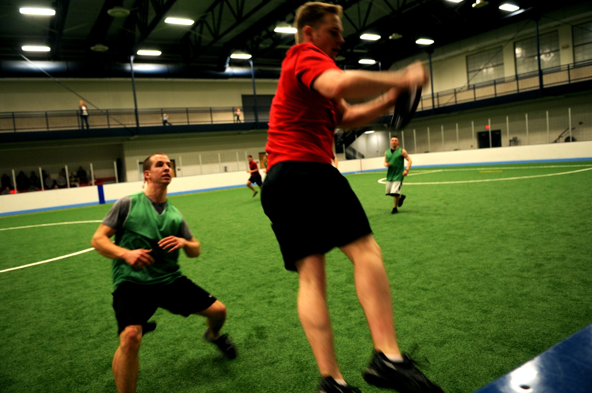 Airman 1st Class Jacob Wallin, 319th Medical Group, watches as Staff Sgt Adam McCormik, 319th Civil Engineer Squadron, makes a catch at the Grand Forks Air Force Base, N.D., Ultimate Frisbee Championship game on March 1, 2012. The 319th Civil Engineer Squadron came out on top with their 5th consecutive championship game win. (U.S. Air Force photo by Staff Sgt. Amanda N. Grabiec)
