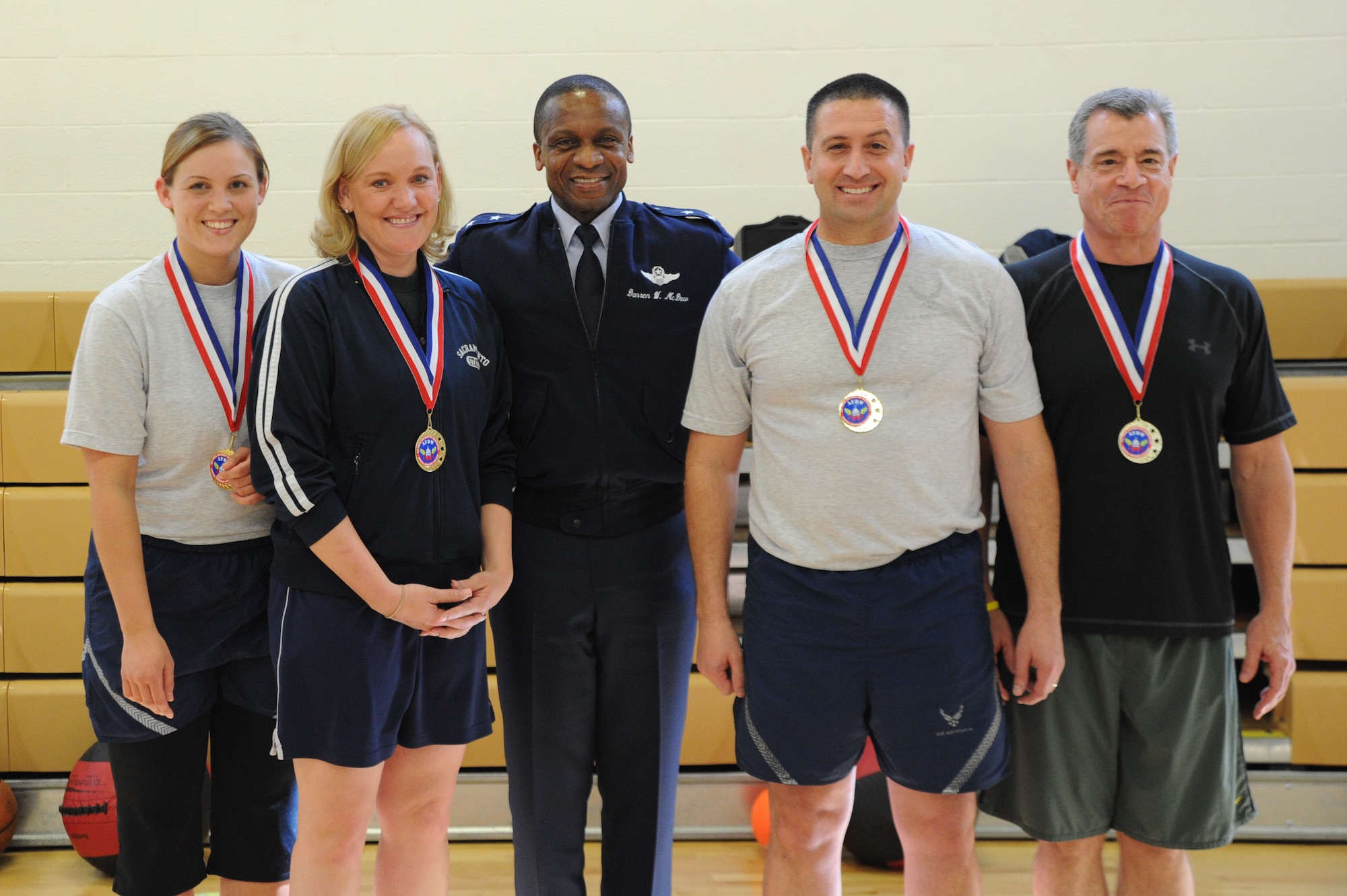 Air Force District of Washington Commander Maj. Gen. Darren W. McDew
congratulates Team Cops Plus One March 1 at the West Fitness Center, Joint
Base Andrews, Md. The team won the distance category in the February Fitness
Challenge, completing more than 15,580 feet. (U.S. Air Force photo by Airman
1st Class Tabitha N. Haynes)
