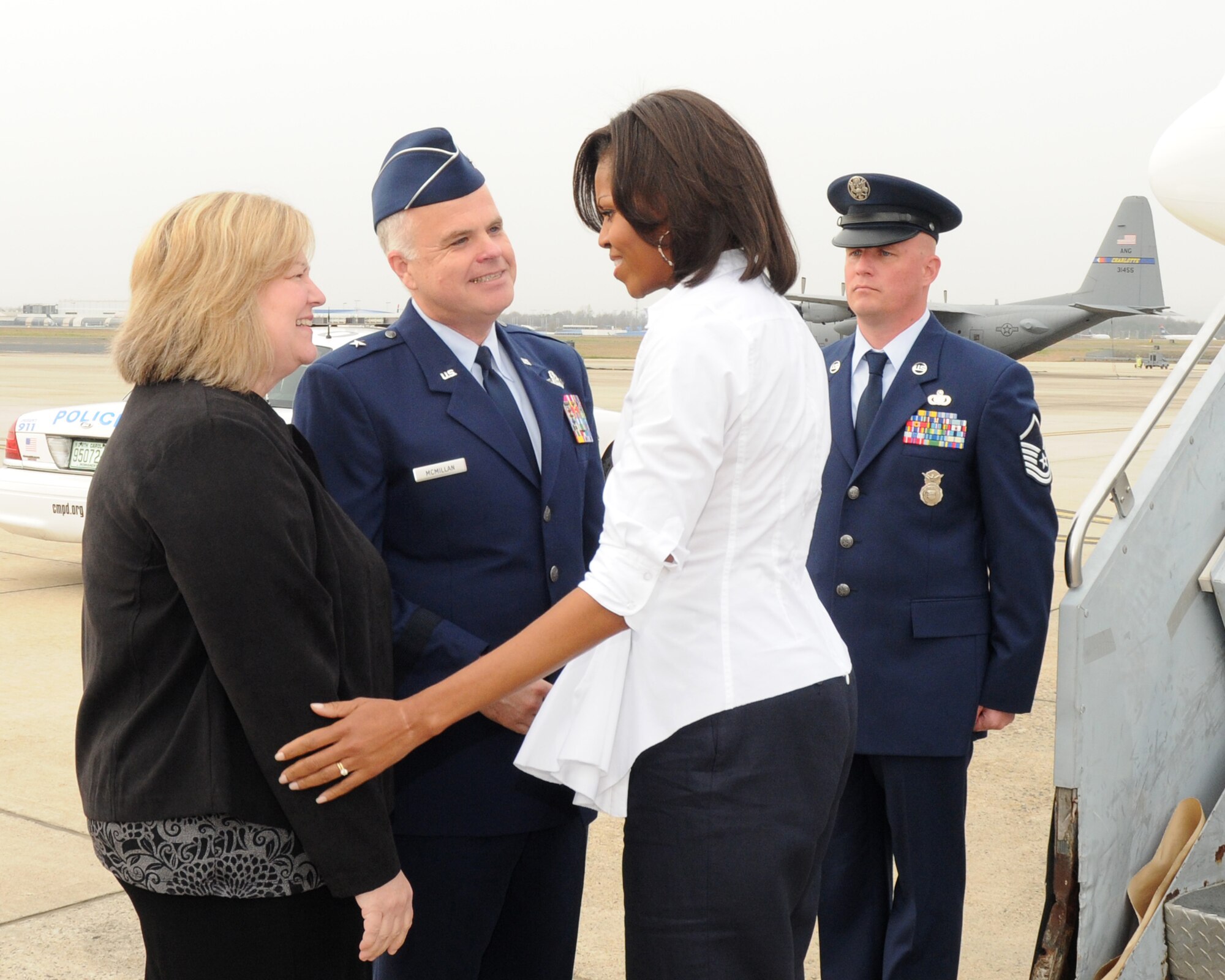 First Lady Michelle Obama is welcomed by Brig. Gen. Tony E. McMillan, 145th Airlift Wing Commander and wife Vickie upon arrival at the  North Carolina Air National Guard Base Charlotte,  N.C.,  March 2, 2012.(Photo by Tech. Sgt. Patricia Findley, 145th AW Public Affairs)