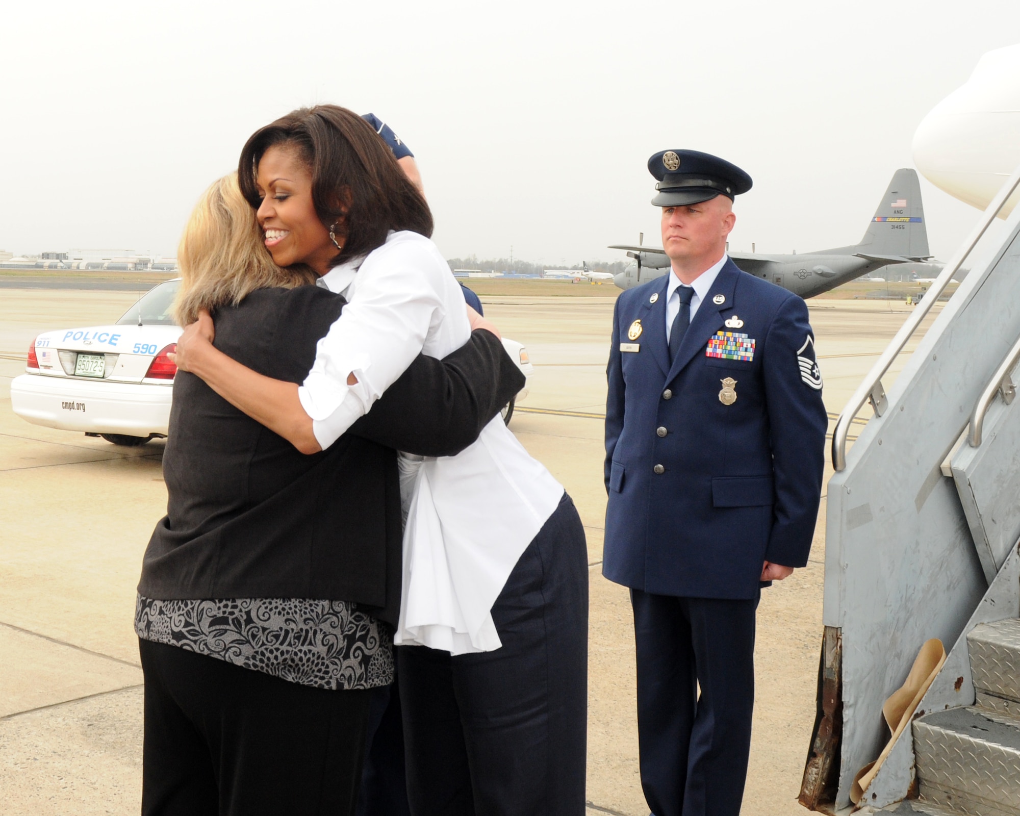 First Lady Michelle Obama hugs  Vickie McMillan wife of  Brig. Gen. Tony E. McMillan, commander of the 145th Airlift Wing, North Carolina Air National Guard upon her  arrival at the  North Carolina Air National Guard Base in Charlotte,  N.C.,  March 2, 2012. (Photo by Tech. Sgt. Patricia Findley, 145th AW Public Affairs)