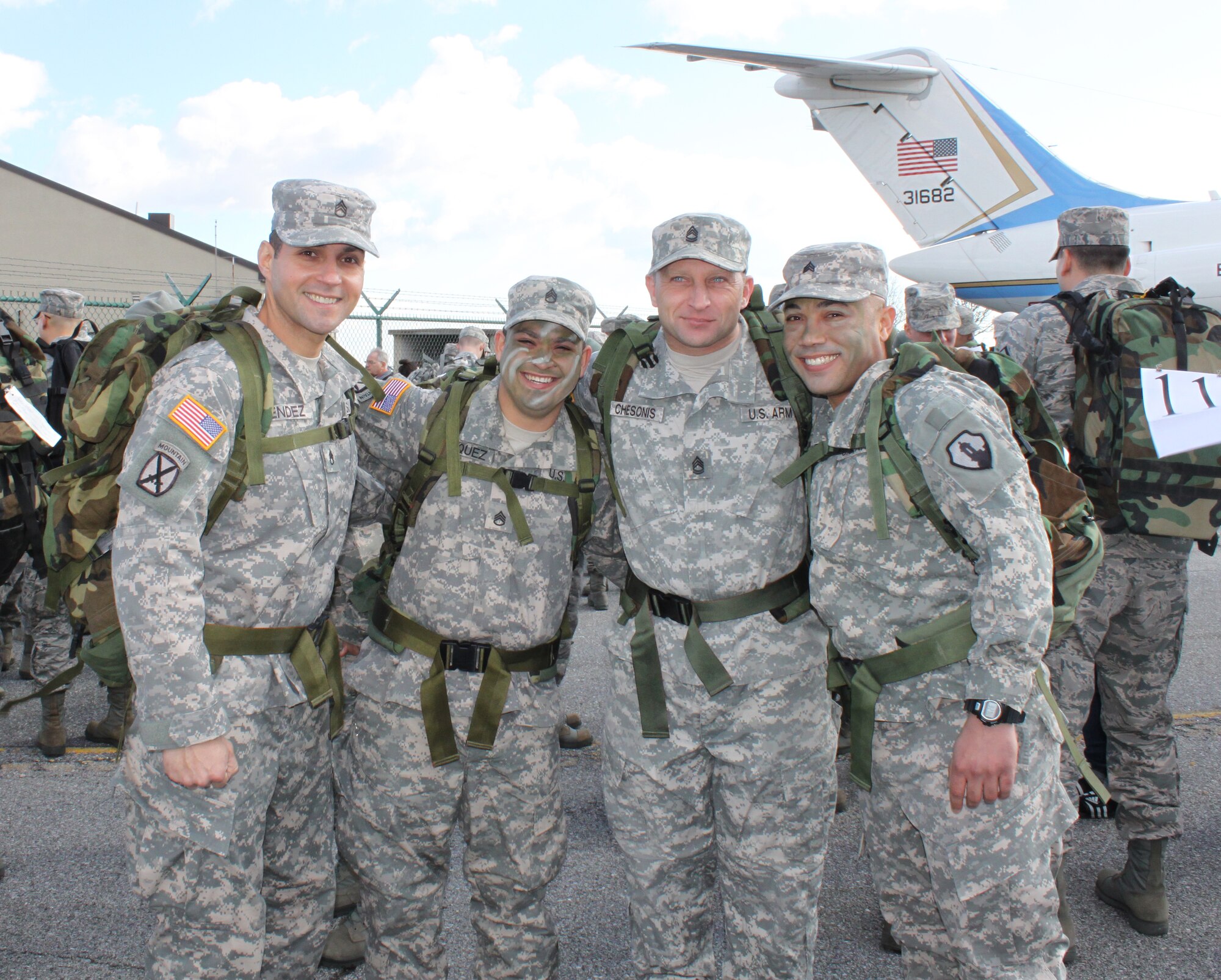 (L to R) Army Staff Sgts. Cesar Mendez and Jose Vazquez, Sergeant 1st Class Christopher Chesonis and Sgt Luis Burgos pose for a photo before the 13th Annual Ruck March at Dover Air Force Base, Del., Feb. 25, 2012. The team of four took the challenge of carrying a 30-pound ruck on the 6.2-mile course. The soldiers are assigned to the Army Liaison team at The Charles C. Carson Center for Mortuary Affairs. (U.S. Air Force photo/Christin Michaud)
