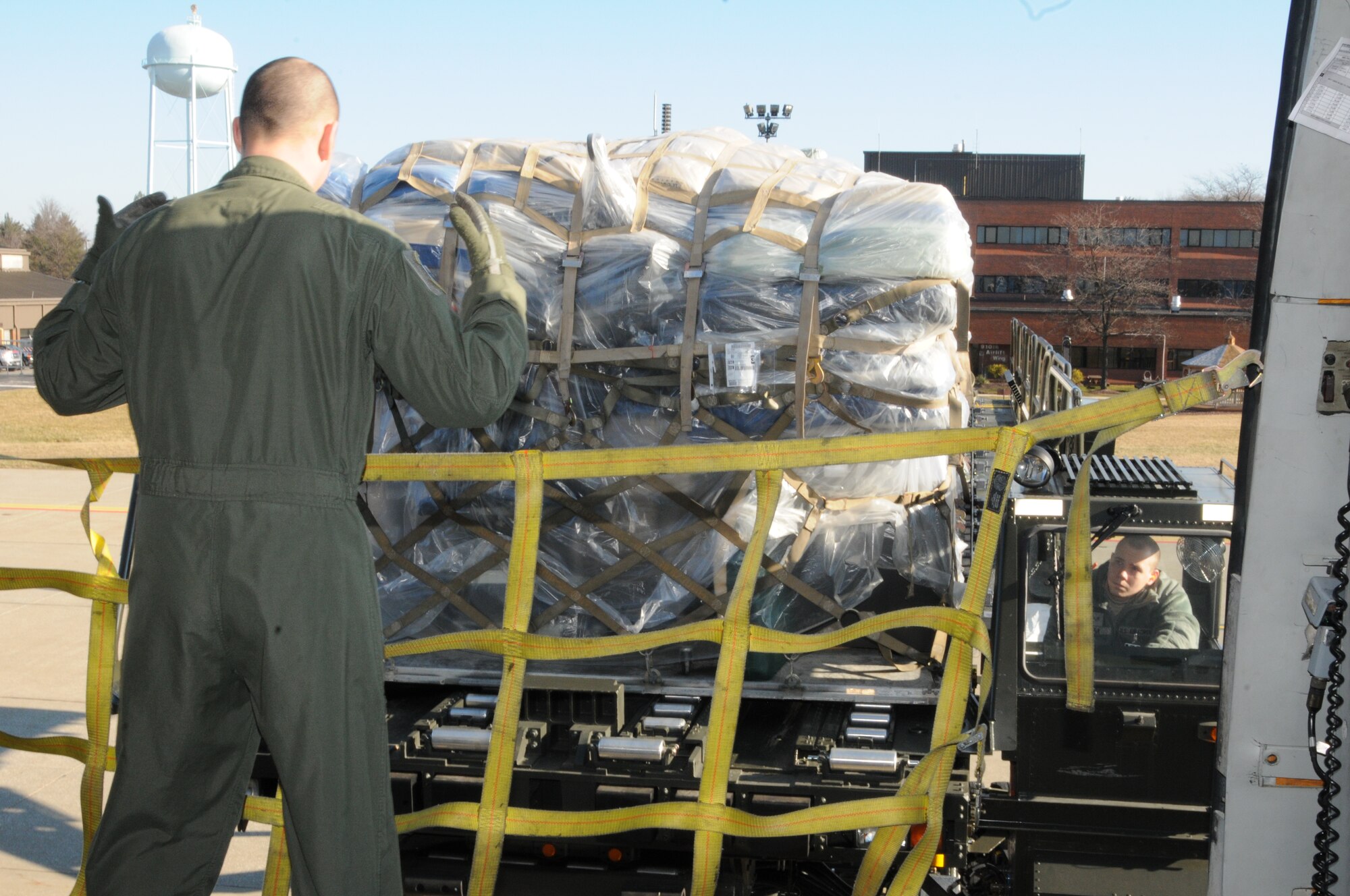 An Air Force Reservist assigned to the 76th Aerial Port Squadron (APS) here, drives a "K-loader" ground cargo transport vehicle full of medical supplies into position for loading at the cargo door of a 305th Air Mobility Wing KC-10 Extender aircraft from Joint Base McGuire-Dix-Lakehurst, NJ. The aircraft stopped at YARS to load cargo for transport to Honduras in conjunction with MedWish International. 76th APS added to a long history of humanitarian support by assisting with the Feb. 2012 mission. U.S. Air Force photo by TSgt. Matt Matulka