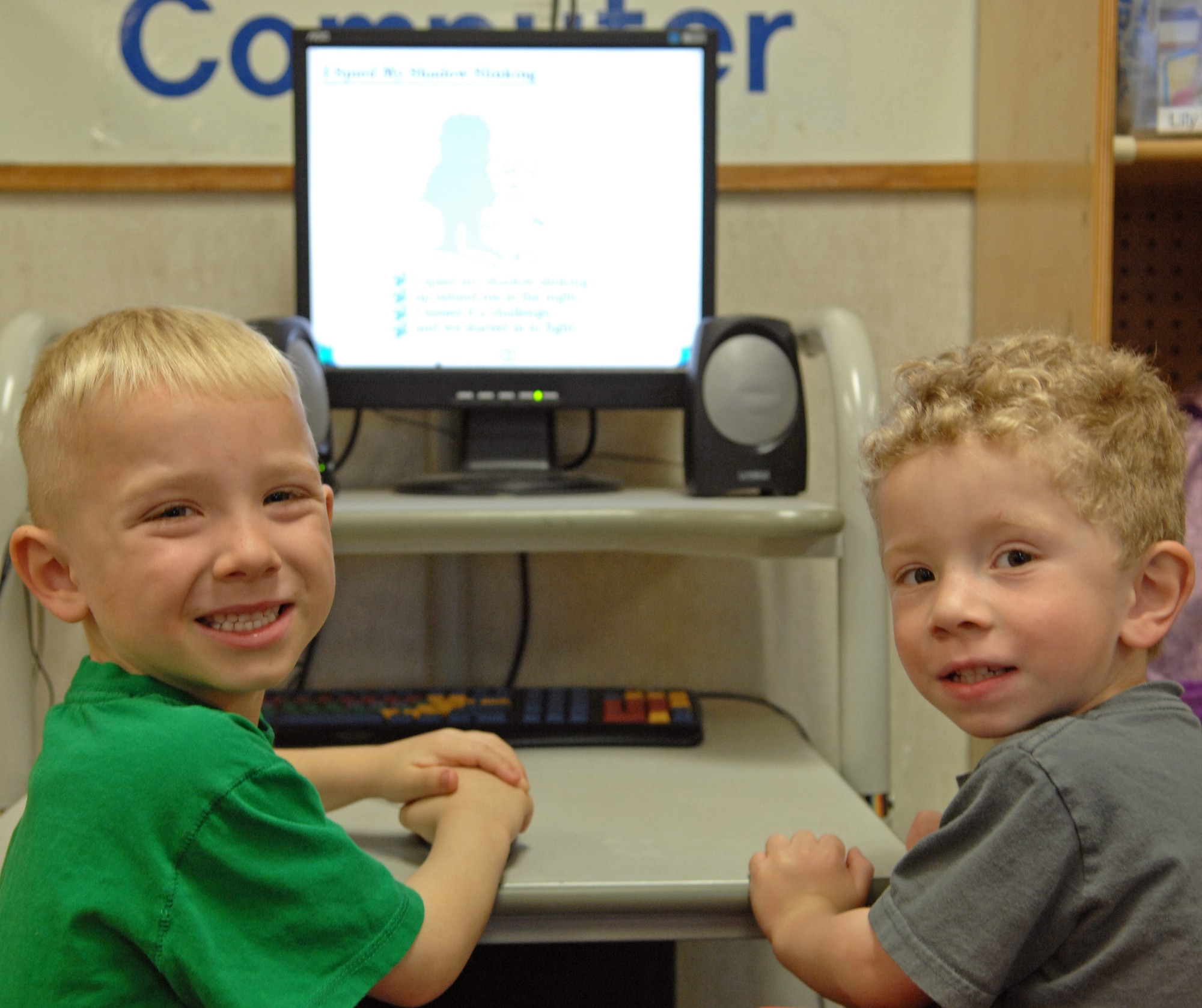 Kyle Konicki , 4, son of Master Sergeants Jeremy and Kristi Konicki and Isaac Gunter, 3, son of Tech. Sergeants Robert and Charita Gunter pose while watching a tutorial on the computer at the Child Development Center on Barksdale Air Force Base, La., Feb. 29. Konicki and Gunter were learning how to use the point and click game where they click on various objects to hear sounds and reveal hidden objects. (U.S. Air Force photo/Airman 1st Class Joseph A. Pagán Jr.)(RELEASED)