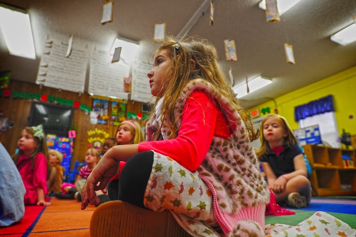 Six-year-old Elliot Tick watches as an Airman reads a book to her and her classmates at St. Andrews Elementary School in Charleston. Members of Joint Base Charleston - Air Base came to the school to read to the children as part of Read Across America Day March 2. The reading celebration is the largest reading event in the nation and occurs each year on or around the birthday of Dr. Seuss. (U.S. Air Force Photo / Staff Sgt. Nicole Mickle)