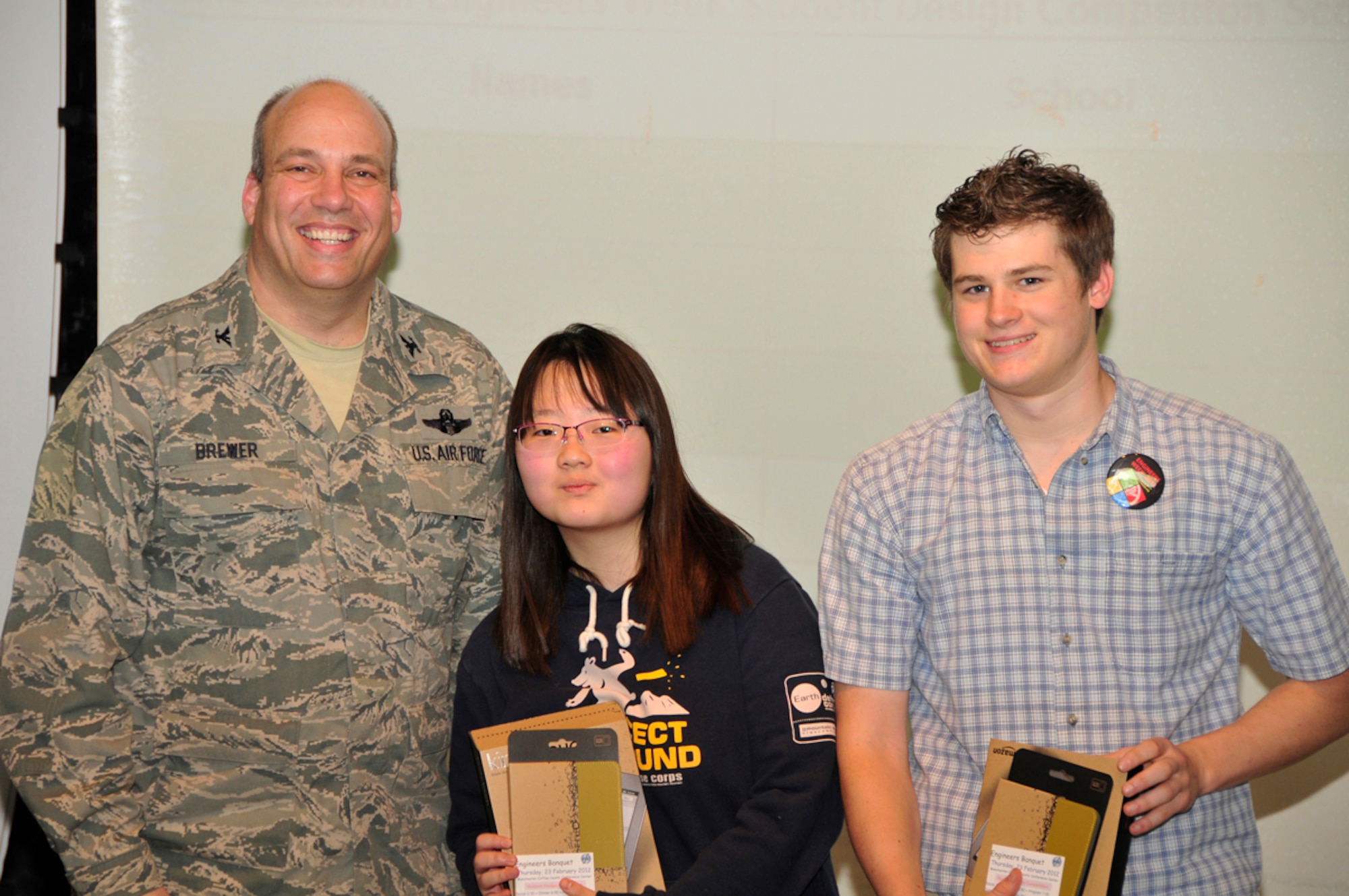 Webb School students Haena Lee and Tyler Burns pose with AEDC Commander Col. Michael Brewer after receiving first place in this year’s Student Design Competition. (Photo by Jacqueline Cowan)