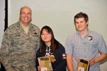 Webb School students Haena Lee and Tyler Burns pose with AEDC Commander Col. Michael Brewer after receiving first place in this year’s Student Design Competition. (Photo by Jacqueline Cowan)