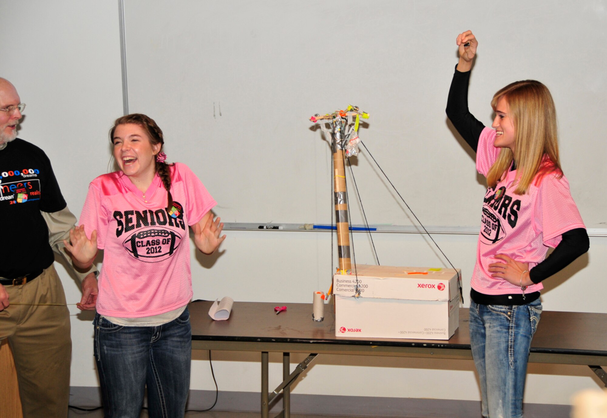Coffee County Central High School students Lainey Wilkins, left, and Brittany Fox celebrate after a successful test of their space elevator at the Student Design Competition held at the Hands-On Science Center Feb. 21. (Photo by Jacqueline Cowan)