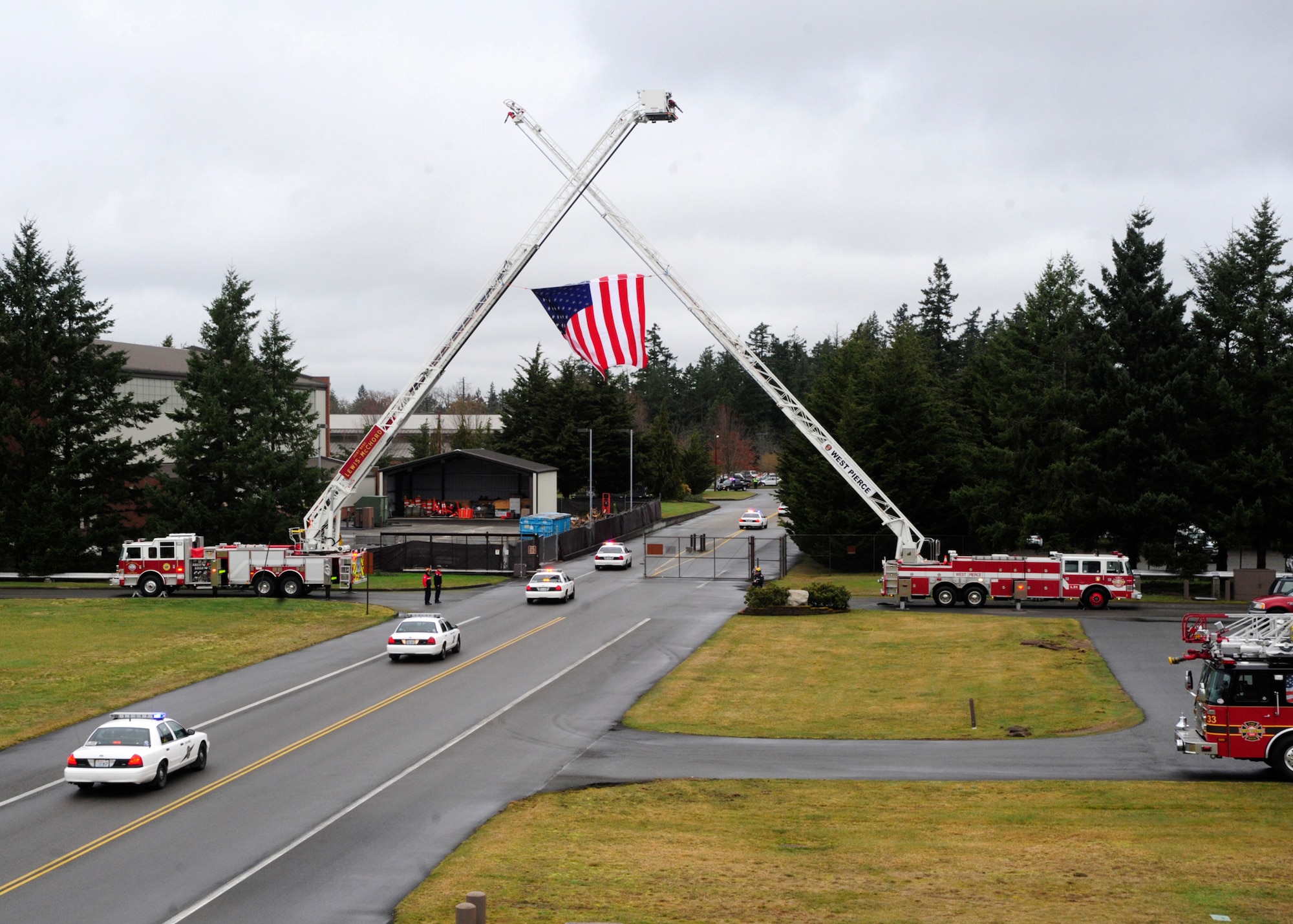Patrol cars exit the gates of Joint Base Lewis-McChord, Wash., March 1, 2012 as part of a procession to a memorial service. The memorial service was in honor of fallen Washington State Patrol Trooper Tony Radulescu, recently killed in the line of duty. (U.S. Air Force photo/Airman 1st Class Leah Young)