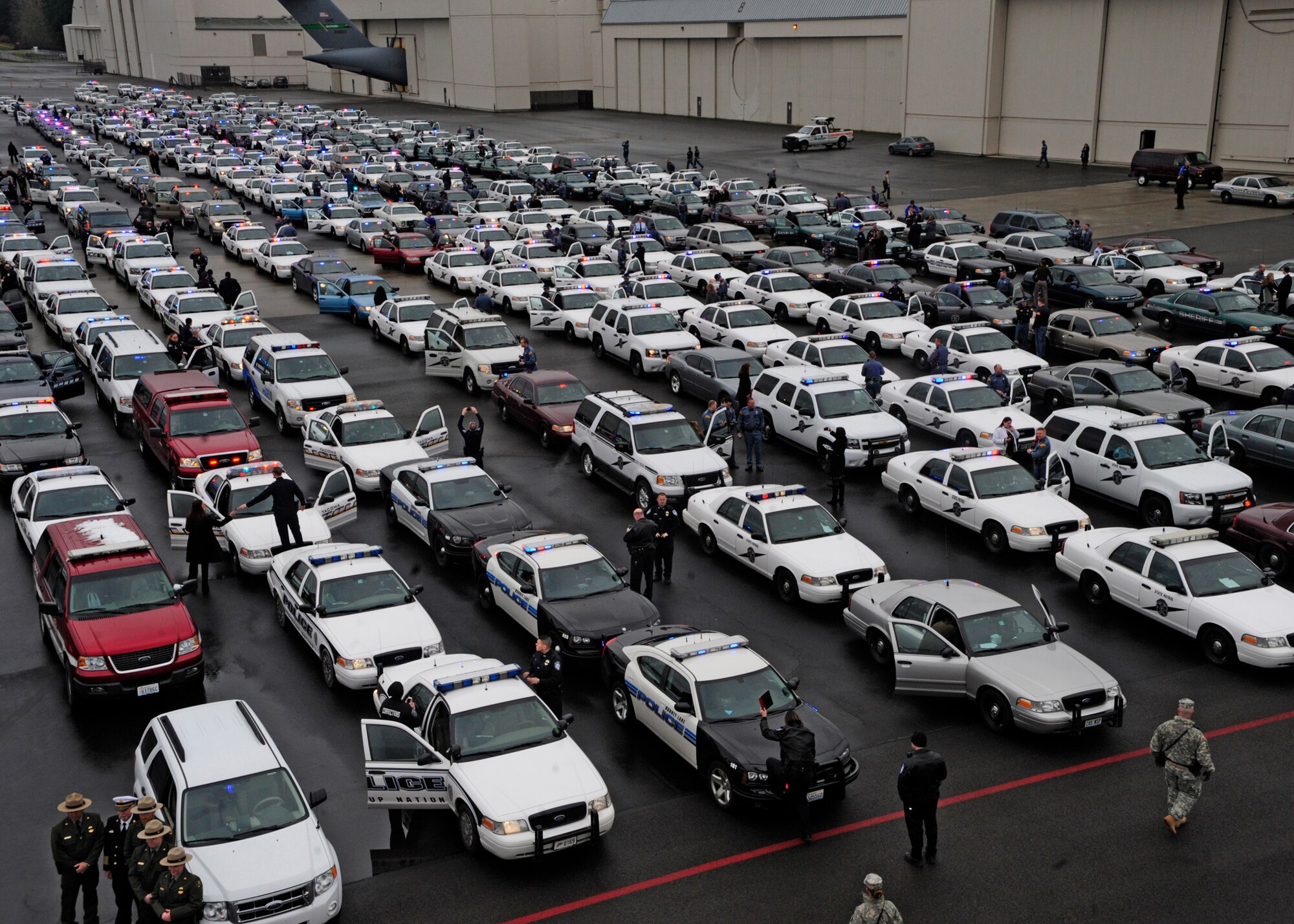 Hundreds of law enforcement personnel from the surrounding community lined up their vehicles prior to the start of a memorial procession March 1, 2012, at Joint Base Lewis-McChord, Wash. The memorial service was in honor of fallen Washington State Patrol Trooper Tony Radulescu, recently killed in the line of duty. (U.S. Air Force photo/Airman 1st Class Leah Young)