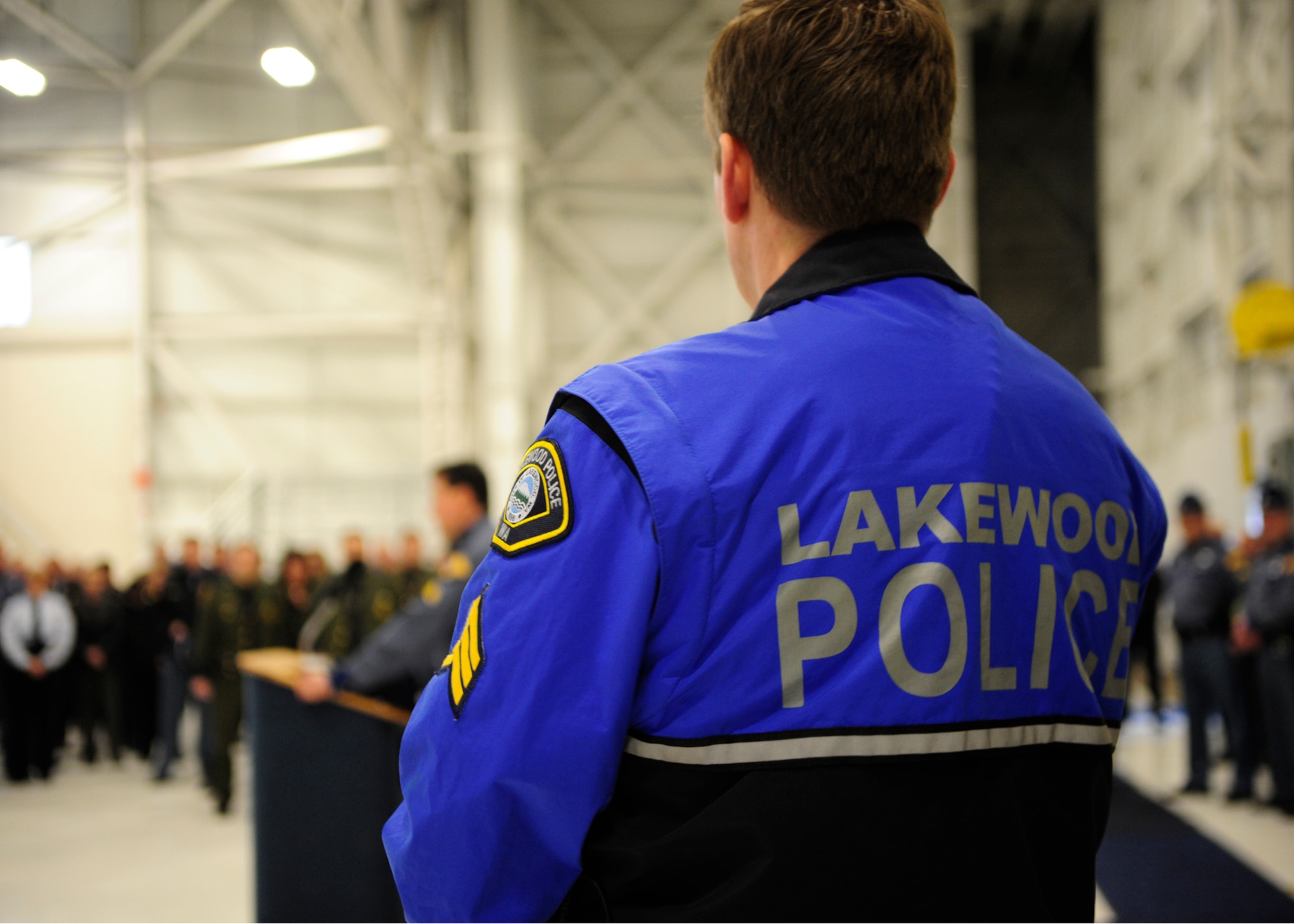A Lakewood police officer listens during a safety briefing before a procession to a memorial service for fallen Washington State Patrol Trooper Tony Radulescu, March 1, 2012, at Joint Base Lewis-McChord, Wash. Before the service, Washington State Patrol Chief John Batiste said it is a "difficult day" for state troopers. (U.S. Air Force photo/Staff Sgt. Frances Kriss)