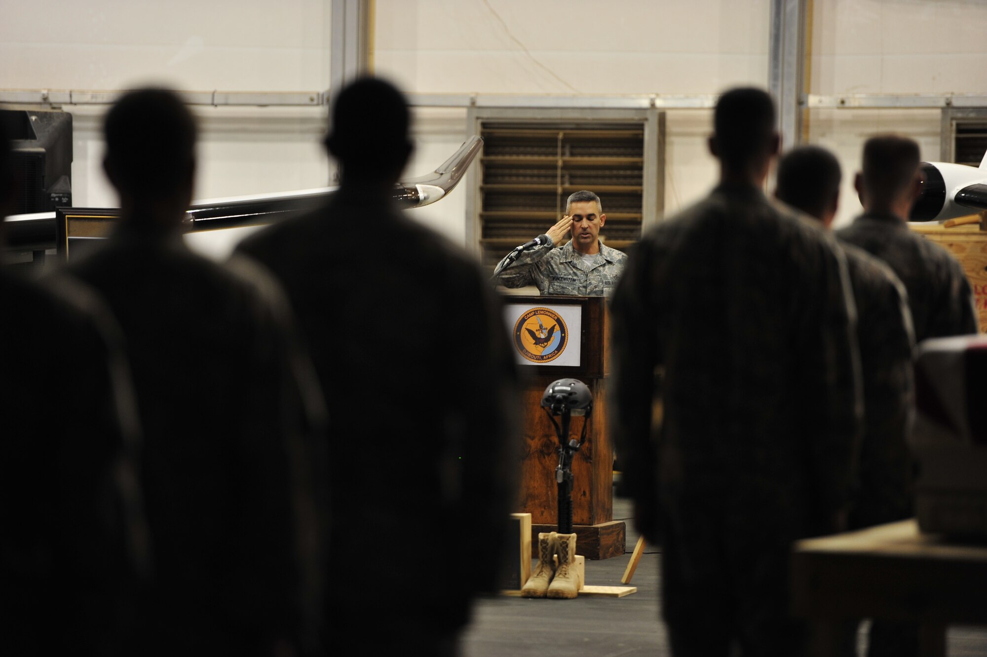 Chief Master Sgt. Christopher Vondenstein, 1st Special Operations Support Squadron, renders a salute during a memorial service at Camp Lemonnier, Djibouti, Feb. 19, 2012. The memorial service honored the service and sacrifice made by Capt. Ryan P. Hall from the 319th Special Operations Squadron, Capt. Nicholas S. Whitlock and 1st Lt. Justin Wilkens from the 34th Special Operations Squadron and Senior Airman Julian S. Scholten from the 25th Intelligence Squadron who all died in a Feb. 18, 2012, U-28A crash in Djibouti, Africa. (U.S. Air Force photo/Staff Sgt. Stephen Linch)