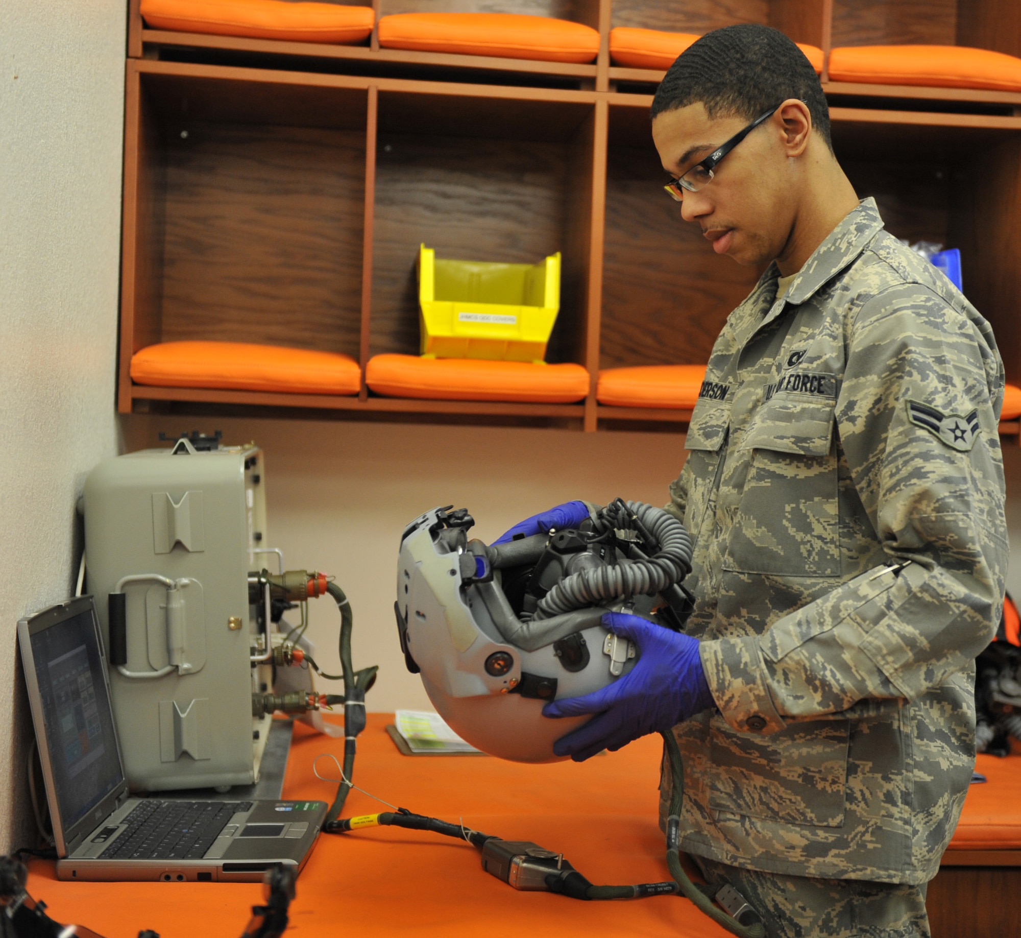 U.S. Air Force Airman 1st Class Albert Anderson, 366th Operations Support Squadron aircrew flight equipment apprentice, checks a pilot’s helmet Feb. 27, 2012, at Mountain Home Air Force Base, Idaho. The equipment technicians perform pre- flight, post-flight and 30 day safety checks of the helmets. (U.S. Air Force photo by Airman 1st Class Heather Hayward/Released)