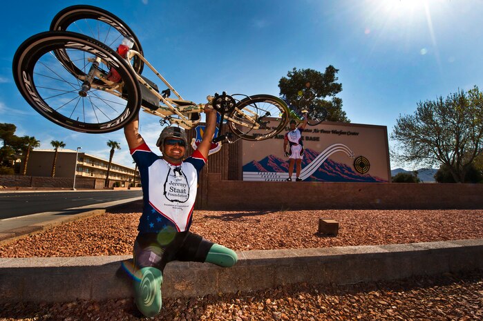 Wesley Leon-Barrientos (left) and Jeremy Staat hold their bicycles above their head at Nellis Air Force Base, Nev., March 1st, 2012, as part of a cross-country bike ride, “Wall to Wall.” Leon-Barrientos and Staat embarked on this endeavor to raise awareness about veteran issues and build unity among American veterans. (U.S. Air Force photo by Senior Airman Brett Clashman
