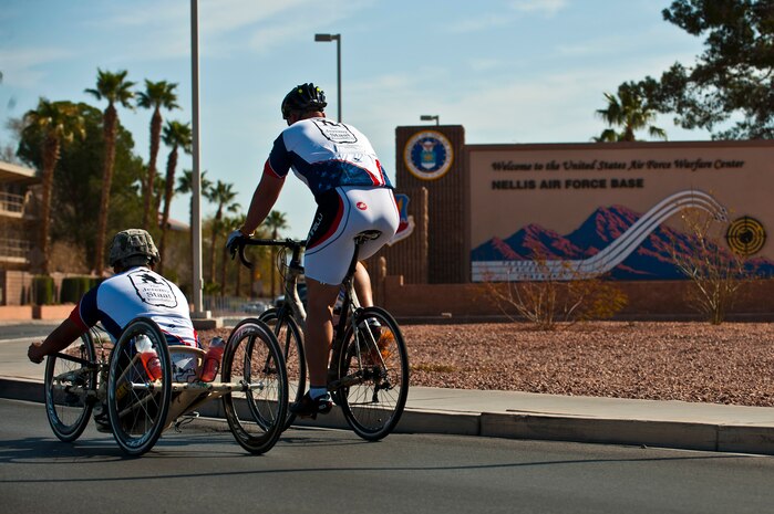 Wesley Leon-Barrientos (left) and Jeremy Staat ride into Nellis Air Force Base, Nev., March 1, 2012, as part of a cross-country bike ride, “Wall to Wall. Leon-Barrientos and Staat embarked on this endeavor to raise awareness about veteran issues and build unity among American veterans. (U.S. Air Force photo by Senior Airman Brett Clashman)

