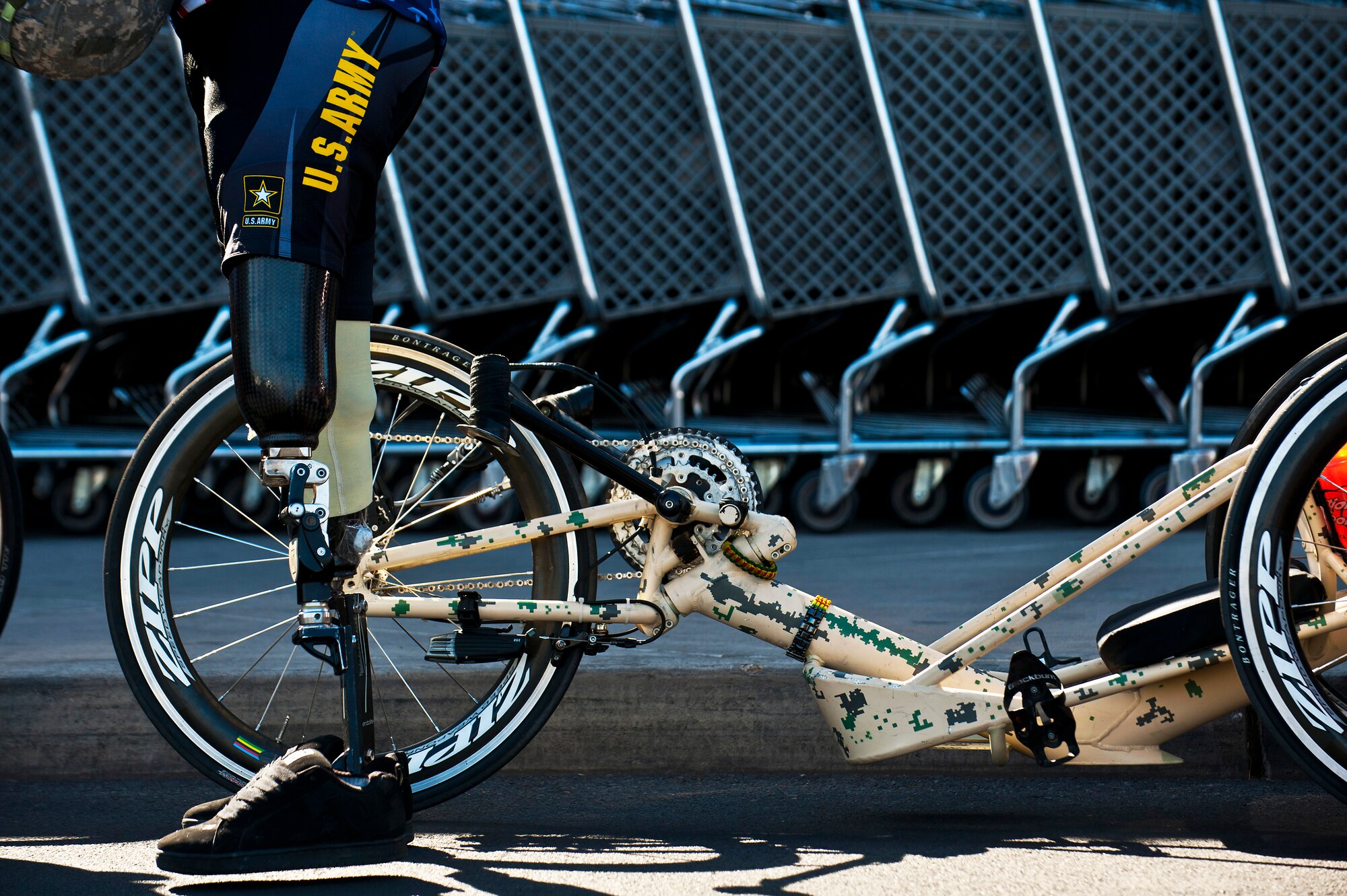 Wesley Leon-Barrientos stands in front of his hand-crank bike at the Base Exchange, March 1, 2012, at Nellis Air Force Base, Nev. Barrientos lost both of his legs while serving in Iraq as a U.S. Army infantryman. Leon-Barrientos and Staat embarked on this endeavor to raise awareness about veteran issues and build unity among American veterans. (U.S. Air Force photo by Senior Airman Brett Clashman)
