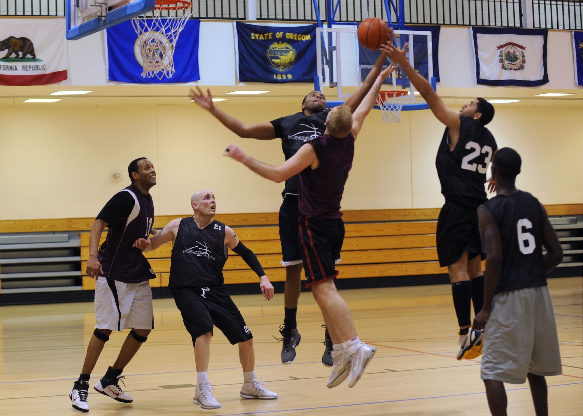 RAF MILDENHALL, England - Players jump for the ball during the RAF Mildenhall Intramural Basketball Championship game here Feb. 28, 2012. The game, between the 100th Civil Engineer Squadron and the 100th Maintenance Group, was close but 100th MXG were able to pull ahead for the win in the second half. (U.S. Air Force photo/Tech. Sgt. Neal X. Joiner) 