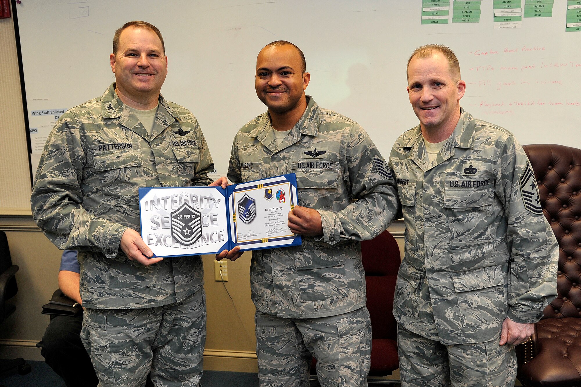 Master Sgt. Isaiah Murray receives a surprise STEP promotion Feb. 28 from Col. Chris Patterson, 621st Contingency Response Wing commander. Murray is a C-17 Globemaster III loadmaster, assigned to the 819th Global Support Squadron. (U.S. Air Force photo by Tech. Sgt. Parker Gyokeres/Released)
