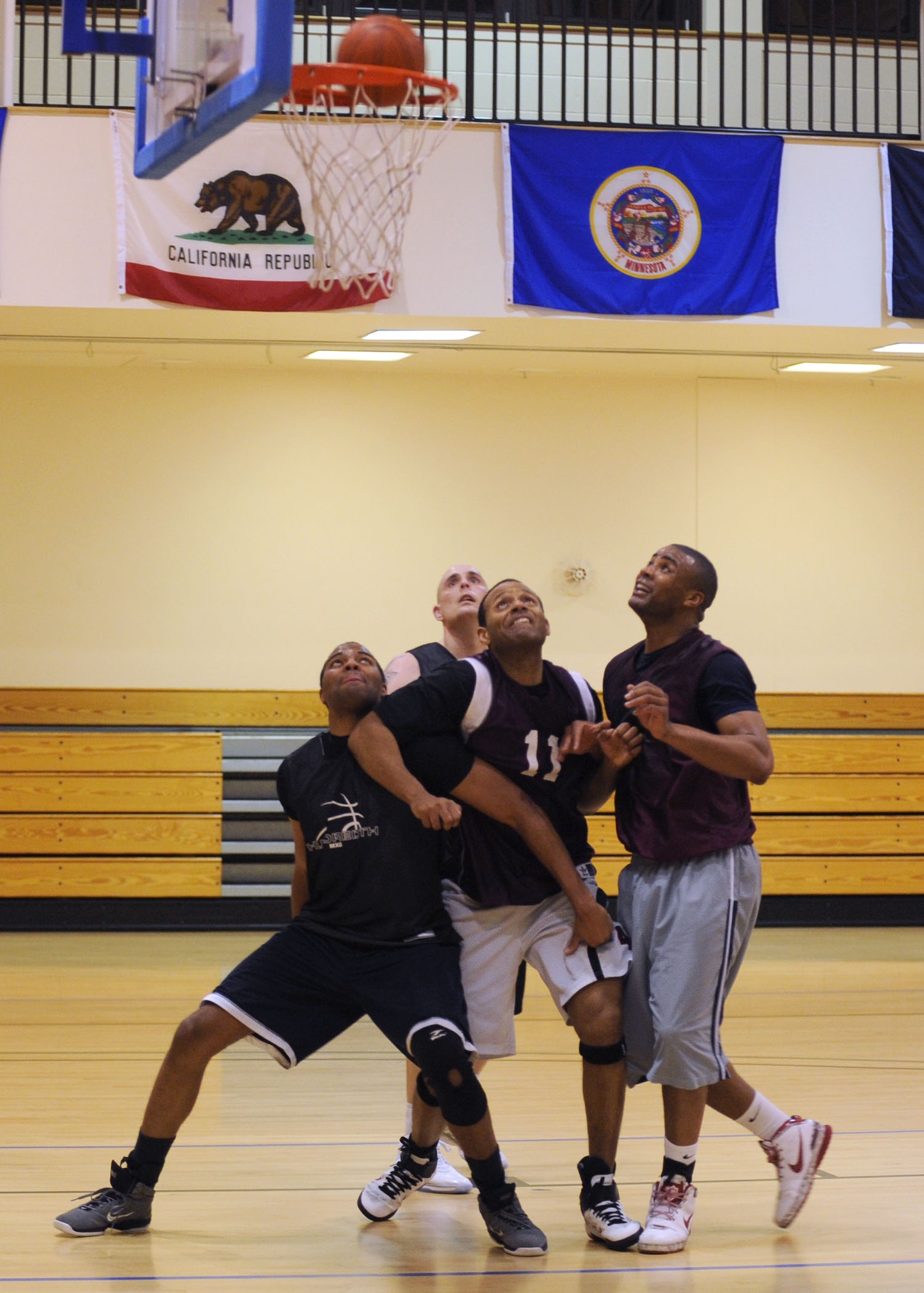 RAF MILDENHALL, England – Players fight for position as they prepare for a potential rebound during the RAF Mildenhall Intramural Basketball Championship game here Feb. 28, 2012. The game, between the 100th Civil Engineer Squadron and the 100th Maintenance Group, was close but 100th MXG were able to pull ahead for the win in the second half. (U.S. Air Force photo/Tech. Sgt. Neal X. Joiner)