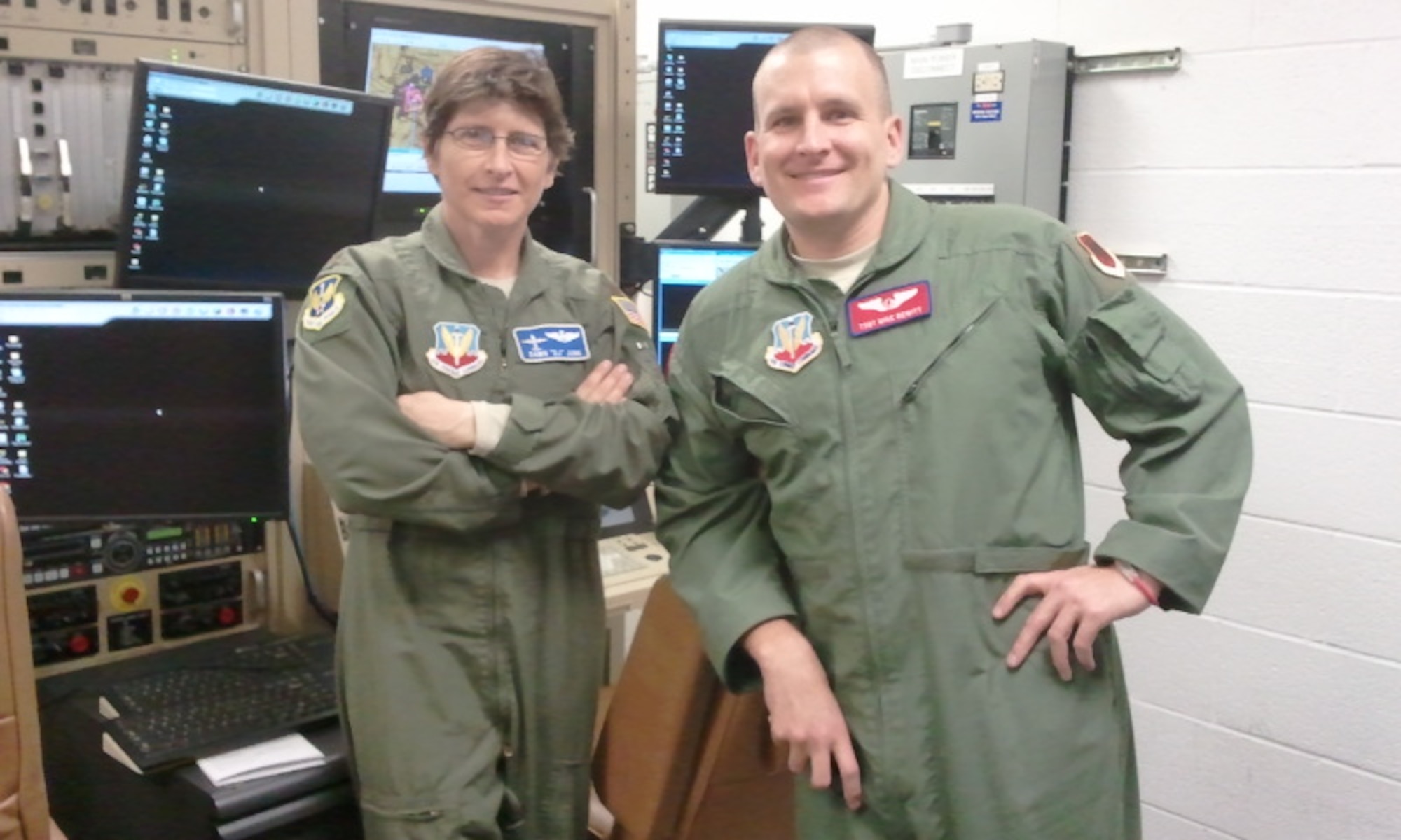 Maj. Dawn Junk, Domestic Operations chief for Air Forces Northern, and Tech. Sgt. Mike DeWitt, a sensor operator from Whiteman Air Force Base, Mo., pause for a photo during MQ-1 Predator training at March Air Reserve Base, Calif. Major Junk is now certified to pilot the unmanned platform, which could potentially help the command save more lives and conduct operations more efficiently during disaster recovery efforts. (Courtesy photo)