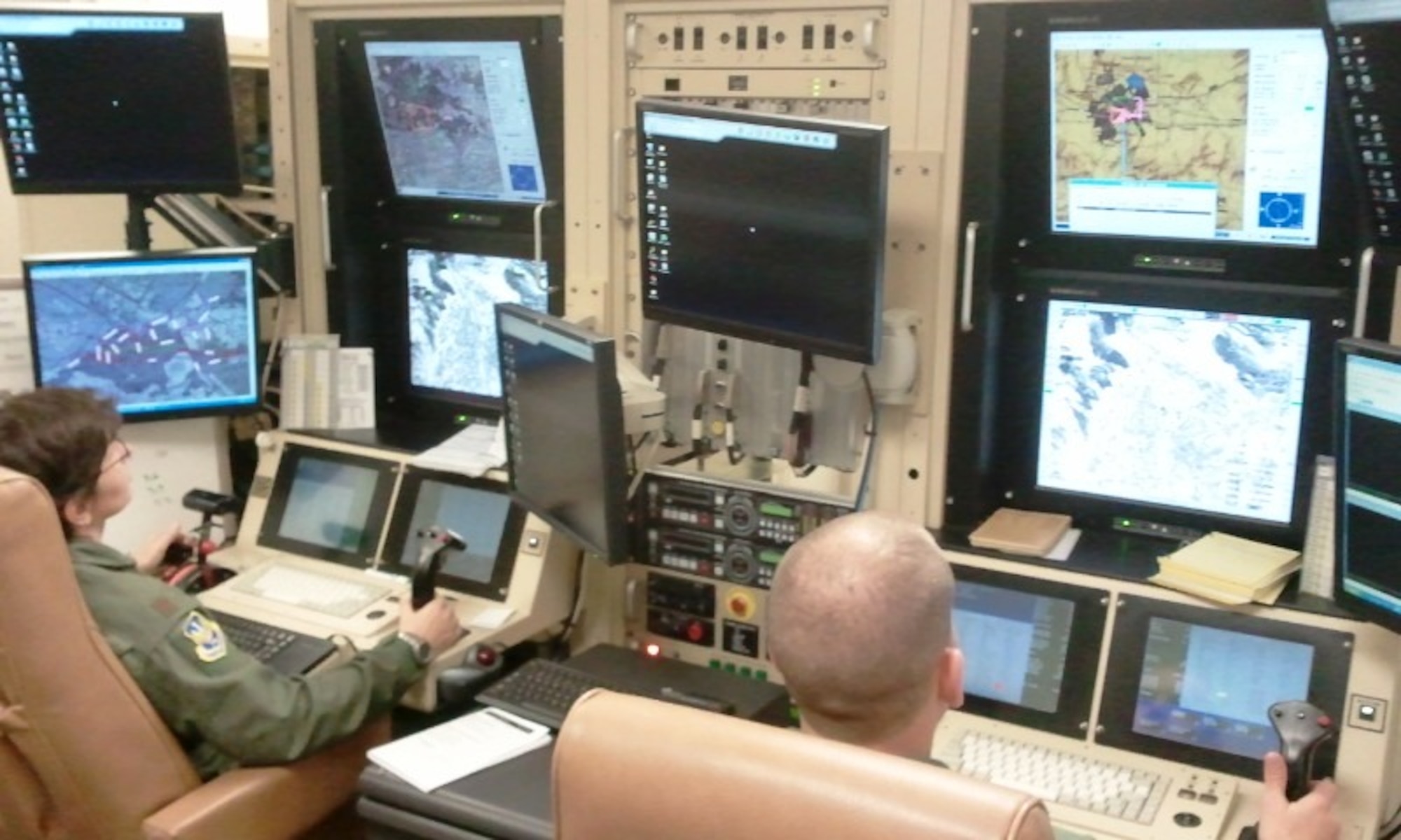 Maj. Dawn Junk, Domestic Operations chief for Air Forces Northern, and Tech. Sgt. Mike DeWitt, a sensor operator from Whiteman Air Force Base, Mo., train on an MQ-1 Predator simulator at March Air Reserve Base, Calif. Major Junk is now certified to pilot the unmanned platform, which could potentially help the command save more lives and conduct operations more efficiently during disaster recovery efforts. (Courtesy photo)