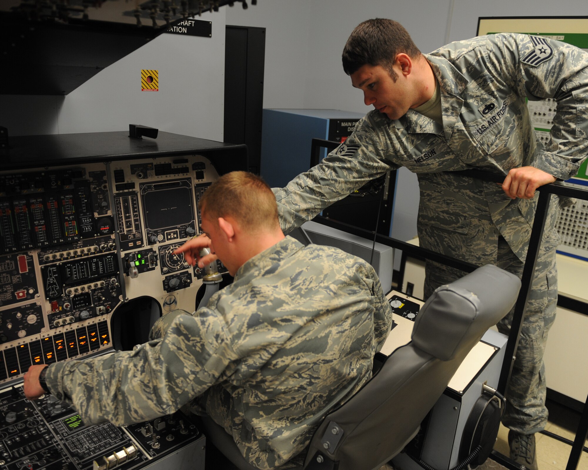 U.S. Air Force Staff Sgt. Brandon Nelson, right, instructs Airman Dylan Sweet, Detachment 20, during B-1 Bomber crew chief training, March 1, 2012, at Dyess Air Force Base, Texas. The crew chiefs in training are completing additional technical training to achieve a journeyman skill level. (U.S. Air Force photo by Airman 1st Class Cierra Bullock/ Released)
