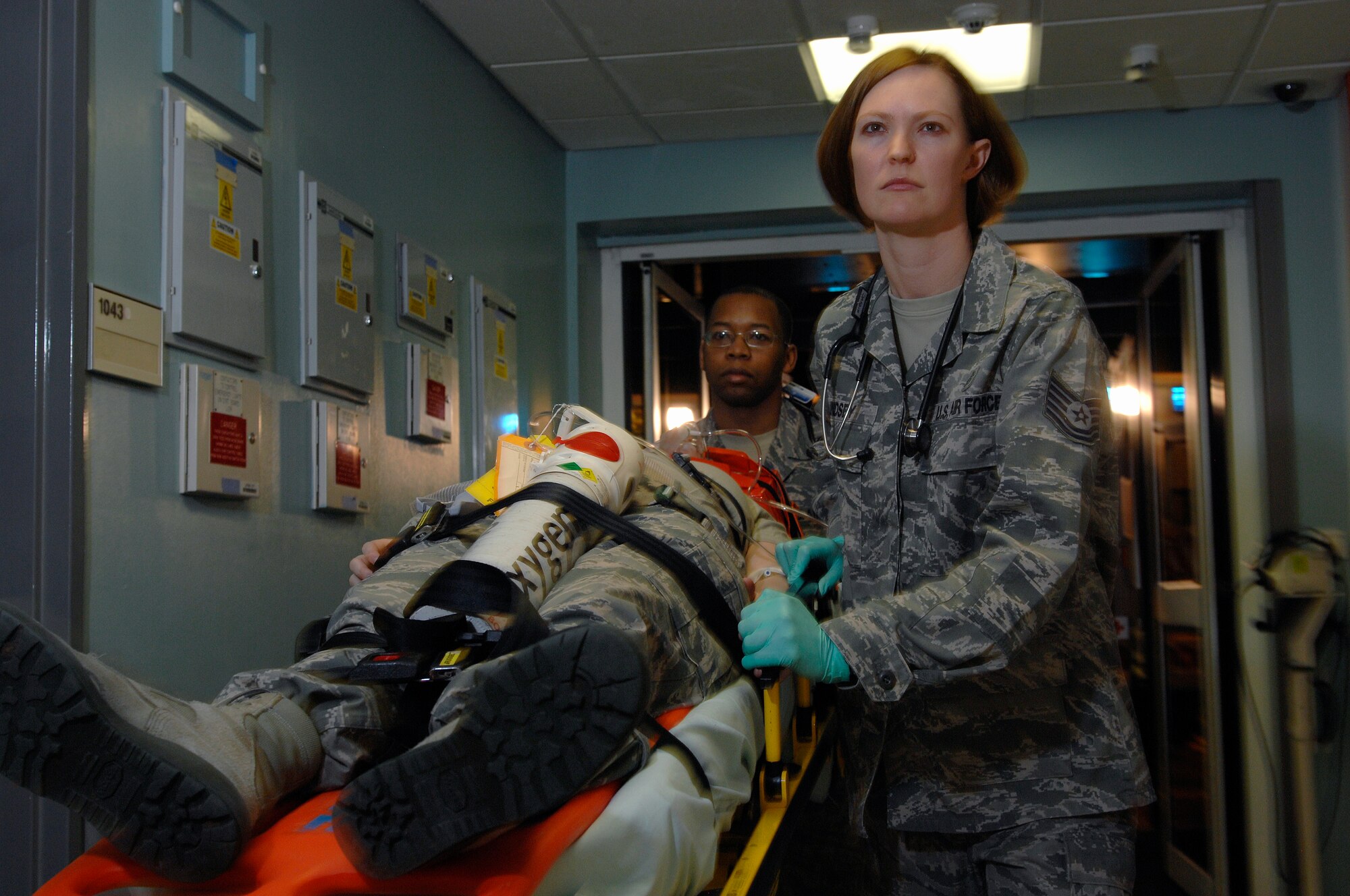 ROYAL AIR FORCE LAKENHEATH, England -- Tech. Sgt. Susanna Lindsey, 48th Medical Operations Squadron emergency room shift leader, and Senior Airman Errington Neysmith, emergency room medical technician, rush a simulated victim into the ER during a training demonstration, Feb. 28, 2012. The ER averages 1,400 visits monthly and supports the combat capability of the 48th Fighter Wing, 100th Air Refueling Wing, 501st Combat Support Wing and 352nd Special Operations Group. The ER is part of the 48th Medical Group, which recently won the Air Force Surgeon General's Best Hospital of the Year for a third year in a row. (U.S. Air Force photo by Tech. Sgt. Lee A. Osberry Jr.)
