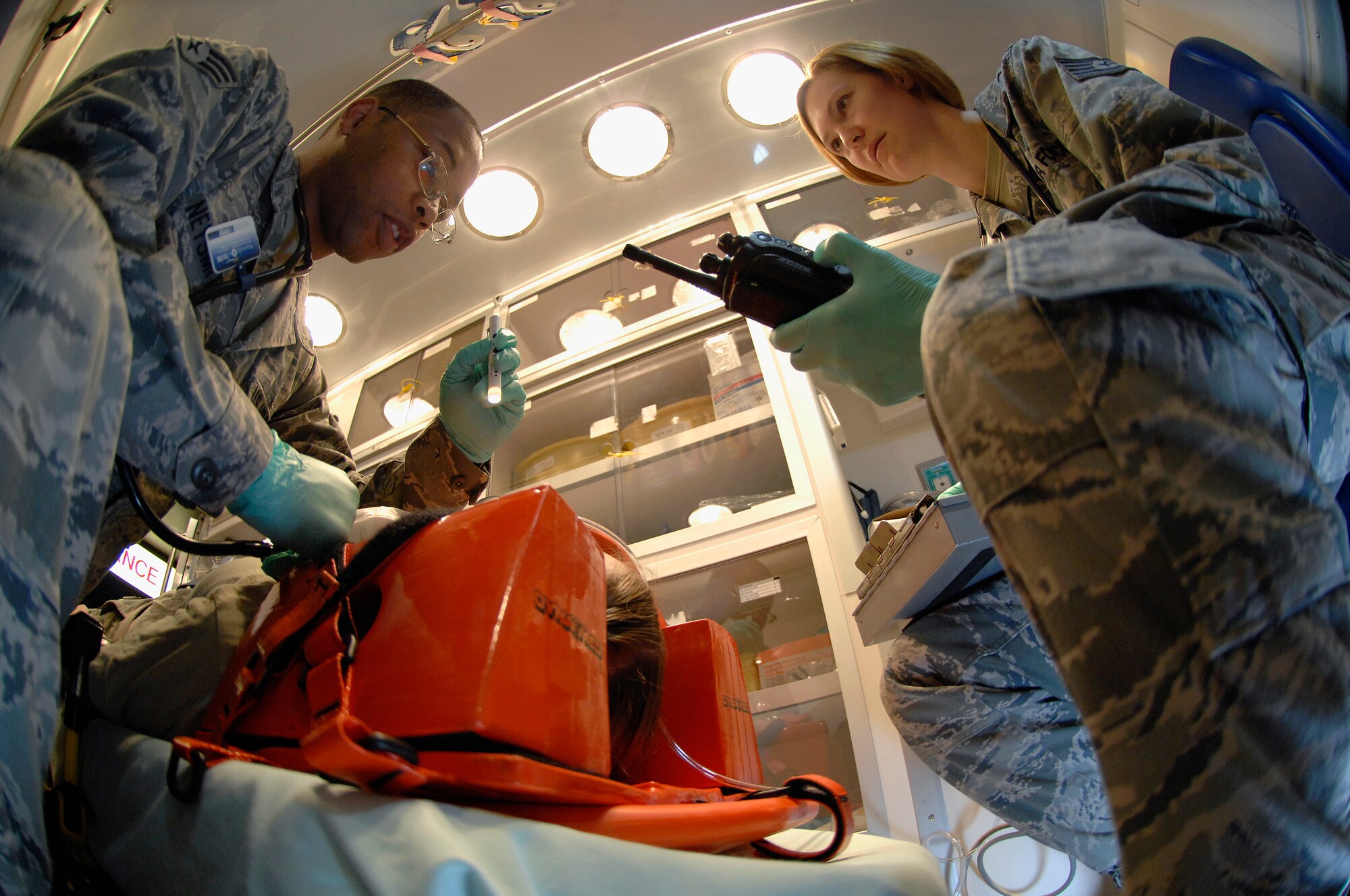 ROYAL AIR FORCE LAKENHEATH, England -- Senior Airman Errington Neysmith, 48th Medical Operations Squadron emergency room medical technician, checks the pupils of a simulated victim, as Tech. Sgt. Susanna Lindsey, 48th MDOS emergency room shift leader, prepares to relay the information during a training demonstration, Feb. 28, 2012. The ER averages 1,400 visits monthly and supports the combat capability of the 48th Fighter Wing, 100th Air Refueling Wing, 501st Combat Support Wing and 352nd Special Operations Group. The ER is part of the 48th Medical Group, which recently won the Air Force Surgeon General's Best Hospital of the Year for a third year in a row. (U.S. Air Force photo by Tech. Sgt. Lee A. Osberry Jr.)
