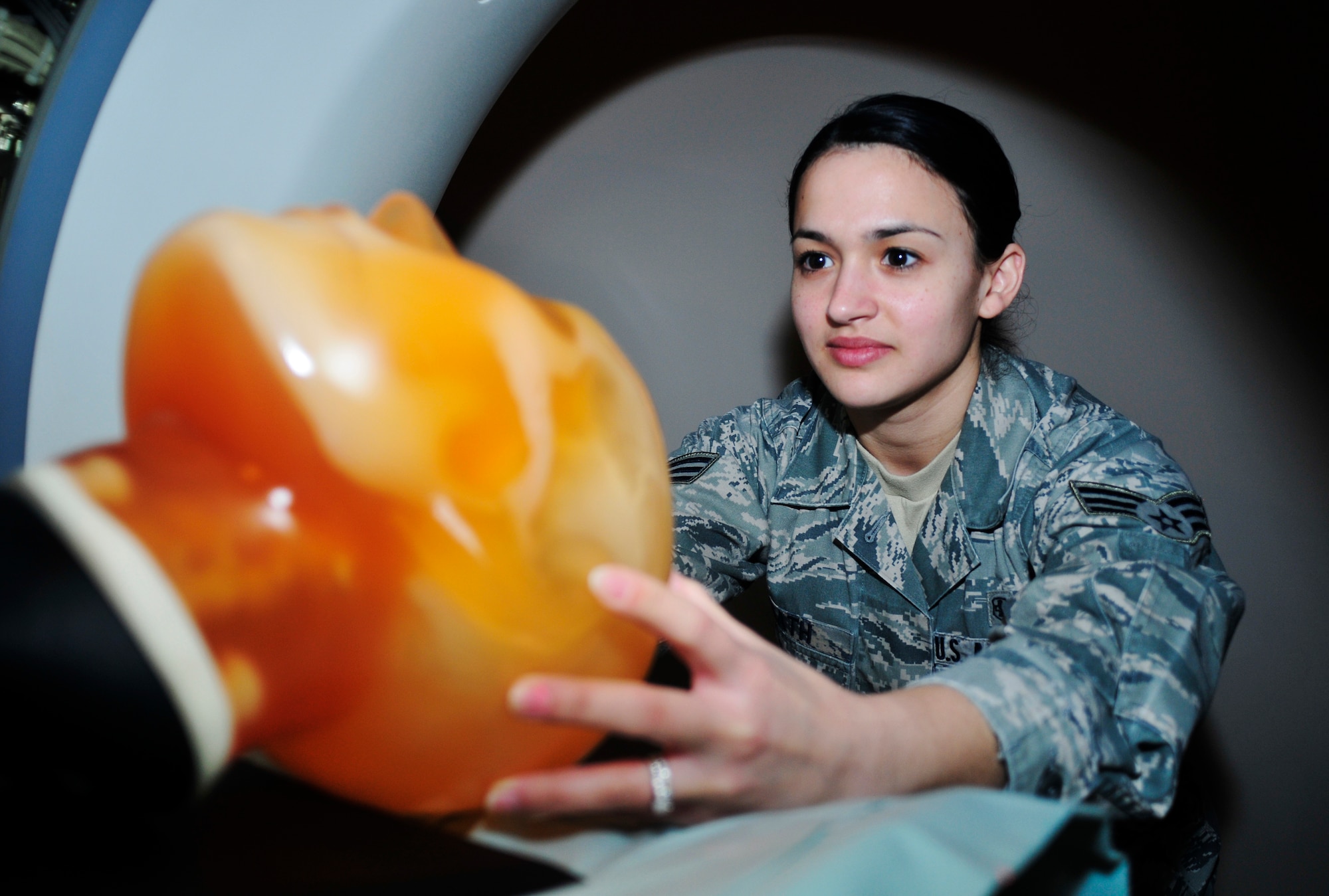 ROYAL AIR FORCE LAKENHEATH, England -- Senior Airman Jenifer Heath, 48th Medical Surgical Squadron diagnostic imaging journeyman, adjusts the head of a dummy for a computed tomography scan in the hospital’s radiology department, Feb. 28, 2012. Radiology averages 32,000 exams monthly and supports the combat capability of the 48th Fighter Wing, 100th Air Refueling Wing, 501st Combat Support Wing and 352nd Special Operations Group. The radiology department is a part of the 48th Medical Group which recently won the Air Force Surgeon General’s Best Hospital of the Year for the third year in a row. (U.S. Air Force photo by Senior Airman Tiffany M. Deuel)
