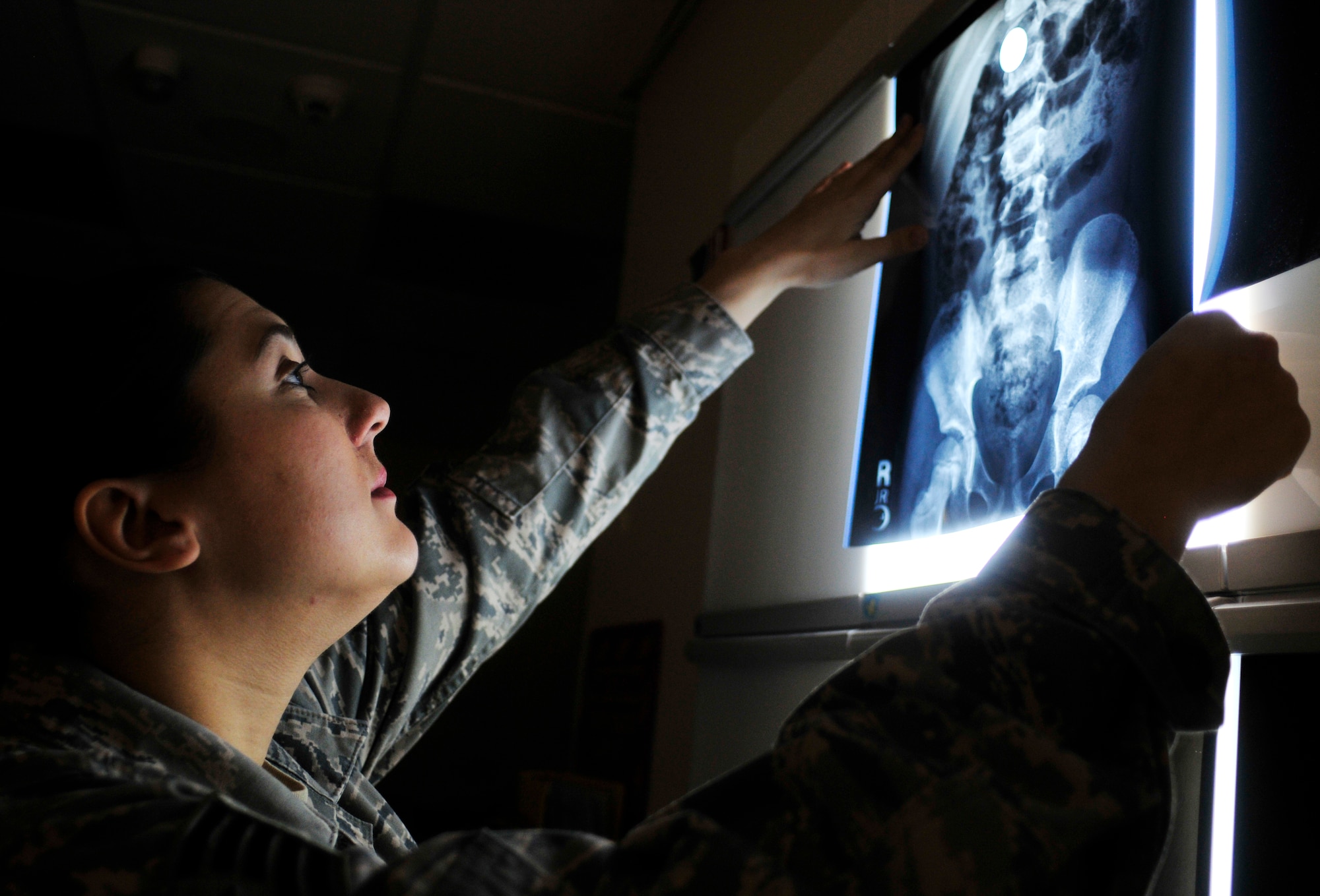 ROYAL AIR FORCE LAKENHEATH, England -- Tech. Sgt. Heather Thomas, 48th Medical Surgical Squadron NCO in charge of computed tomography, looks at an x-ray in the hospital’s radiology department, Feb. 28, 2012. Radiology averages 32,000 exams monthly and supports the combat capability of the 48th Fighter Wing, 100th Air Refueling Wing, 501st Combat Support Wing and 352nd Special Operations Group. The radiology department is a part of the 48th Medical Group which recently won the Air Force Surgeon General’s Best Hospital of the Year for the third year in a row. (U.S. Air Force photo by Senior Airman Tiffany M. Deuel)
