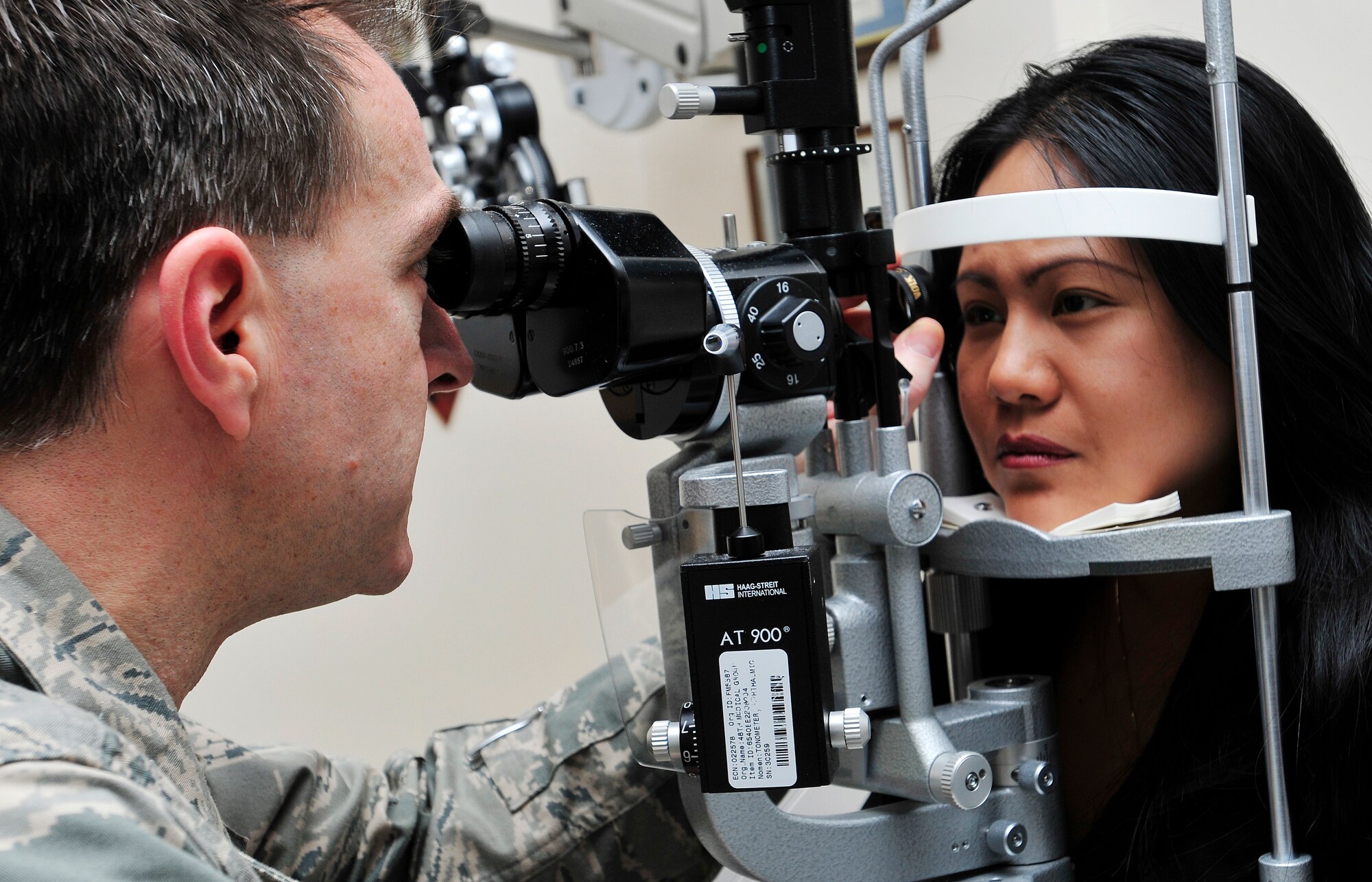 ROYAL AIR FORCE LAKENHEATH, England -- Lt. Col. (Dr.) John Mileski, 48th Aerospace Medical Squadron Optometry flight commander, checks the eyes of a patient in the hospital’s optometry department, Feb. 28, 2012. The optometry flight performs 9,720 exams annually and is part of the 48th Medical Group, which recently won the Air Force Surgeon General’s Best Hospital of the Year for the third year in a row. (U.S. Air Force photo by Senior Airman Tiffany M. Deuel)