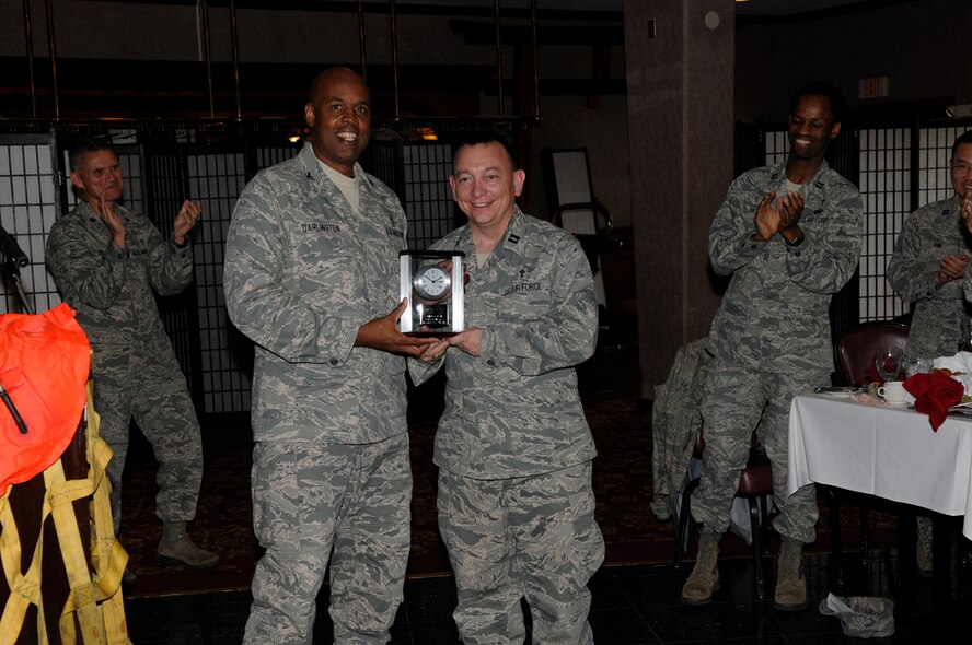 U.S. Air Force Chaplain (Col.) Keith Darlington, Pacific Air Forces command chaplain, presents Chaplain (Capt.) Kevin Humphrey, an 18th Wing chaplain, with the Edwin R. Chess Award, or the outstanding company-grade chaplain award, during the National Prayer Luncheon at the Rocker NCO Club on Kadena Air Base, Japan, Feb. 29, 2012. This year's theme, 'Heroes of Faith', honored four chaplains who gave their lives to help save other soldiers aboard a U.S. Army transport ship that had been hit by a torpedo. (U.S. Air Force photo by Airman 1st Class Tara A. Williamson/Released)