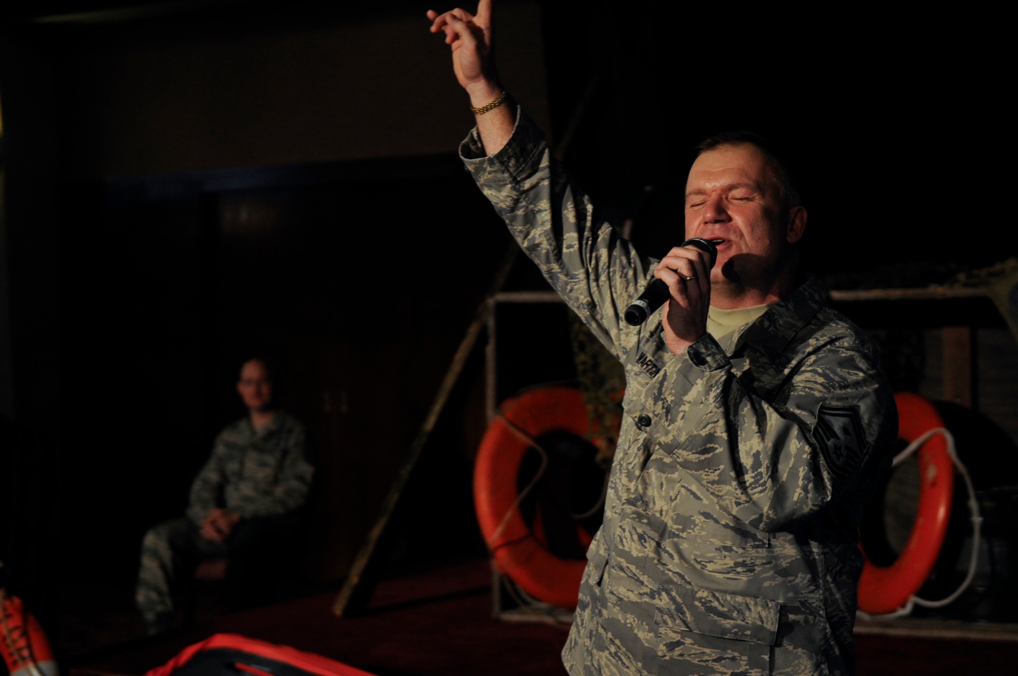 U.S. Air Force Senior Master Sgt. Robert Martin, 18th Component Maintenance Squadron first sergeant, performs an uplifting song during the National Prayer Luncheon at the Rocker NCO Club on Kadena Air Base, Japan, Feb. 29, 2012. This year's theme, 'Heroes of Faith', honored four chaplains who gave their lives to help save other soldiers aboard a U.S. Army transport ship that had been hit by a torpedo. (U.S. Air Force photo by Airman 1st Class Tara A. Williamson/Released)