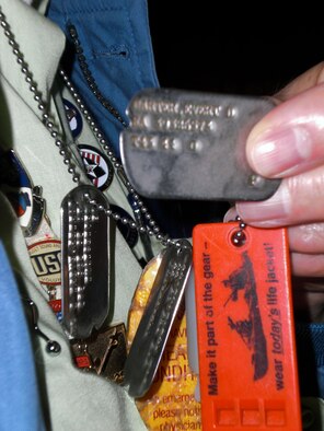 Retired U.S. Army 1st Sgt. Evert “Sarge” Carter displays his original World War II notched dog tags at the Seattle-Tacoma International Airport, Feb. 8, 2012. As a four-war veteran, he has a unique historical perspective because of his participation in certain units and fights, including the “Bushmasters,” Battle of Saipan and Battle of Osan. (U.S. Air Force photo by Senior Airman Brigitte N. Brantley/Released)